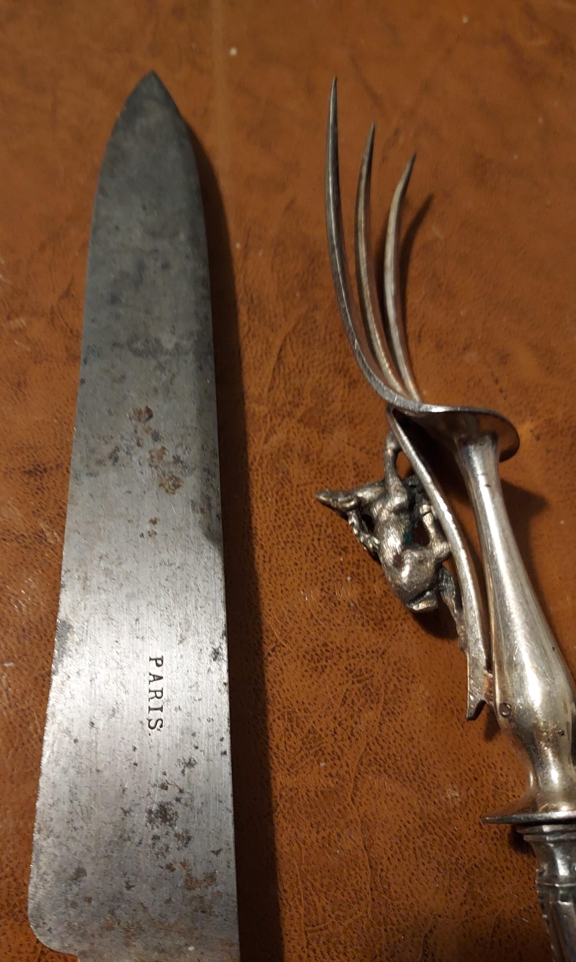 Antique Silver Carving Set of Knife and Fork embellished with a protective Stag
This set is particularily good and beautifull an excellent steel knife blade needs polishing given.  there is silver missing which can be seen clearly on the hillt where