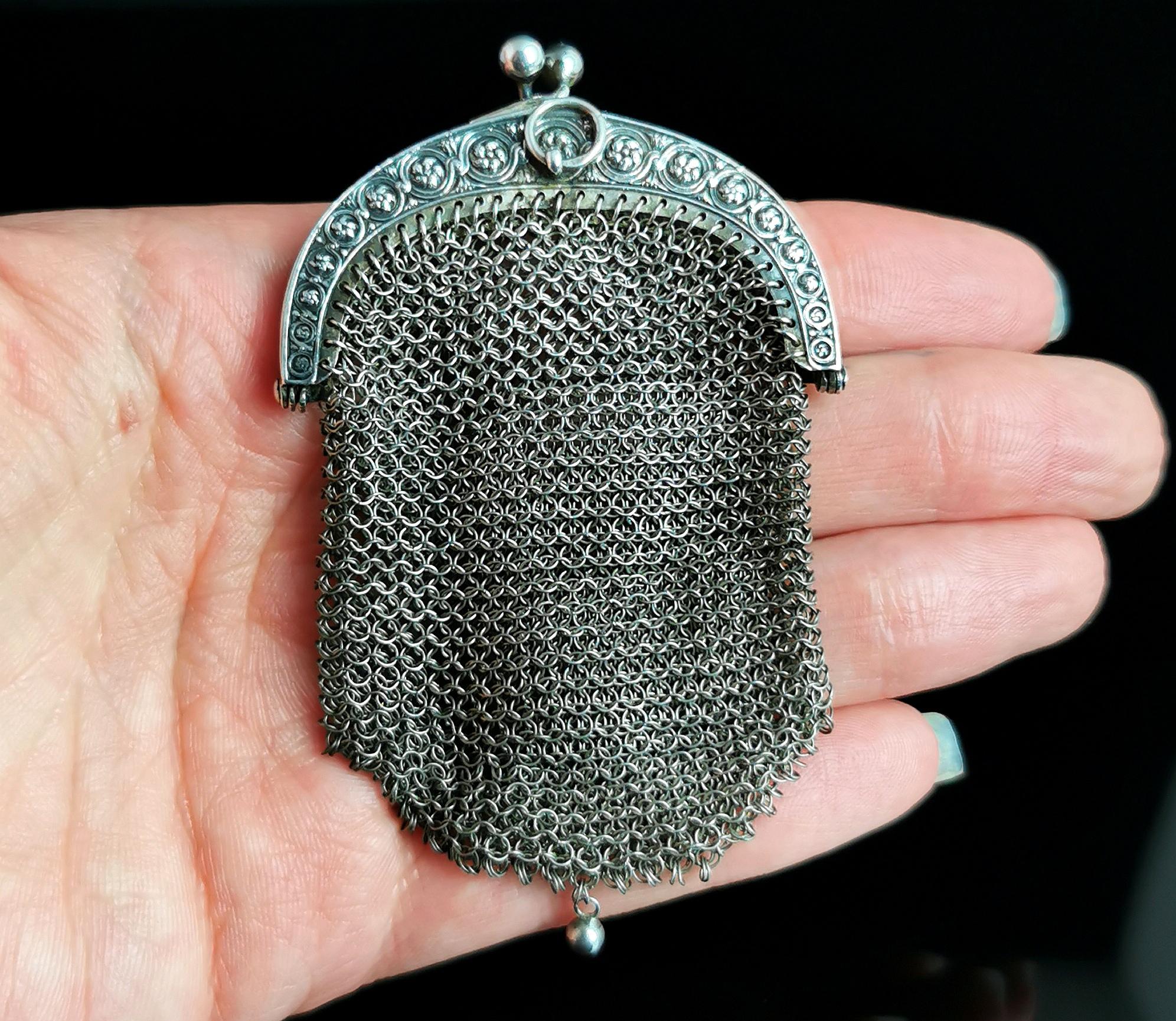 A stunning antique German silver chatelaine purse.

The body is made up from intricately woven and delicate 800 silver mesh with fine detailing to each ring.

The base of the purse features a single beaded drop and it has a wonderfully pretty floral