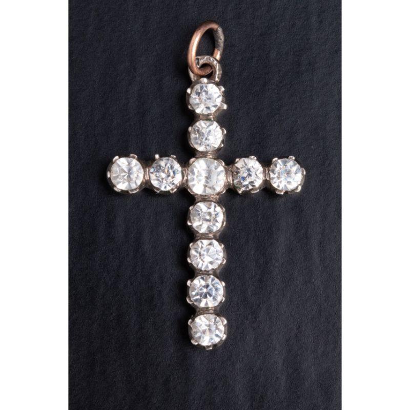 A lovely silver cross pendant with a gold bail set with 11 old cut diamond paste stones.

Made of solid silver and dating back to the early 1900's this cross is a revival of late Georgian diamond crosses. The pendant is set with 11 old cut paste