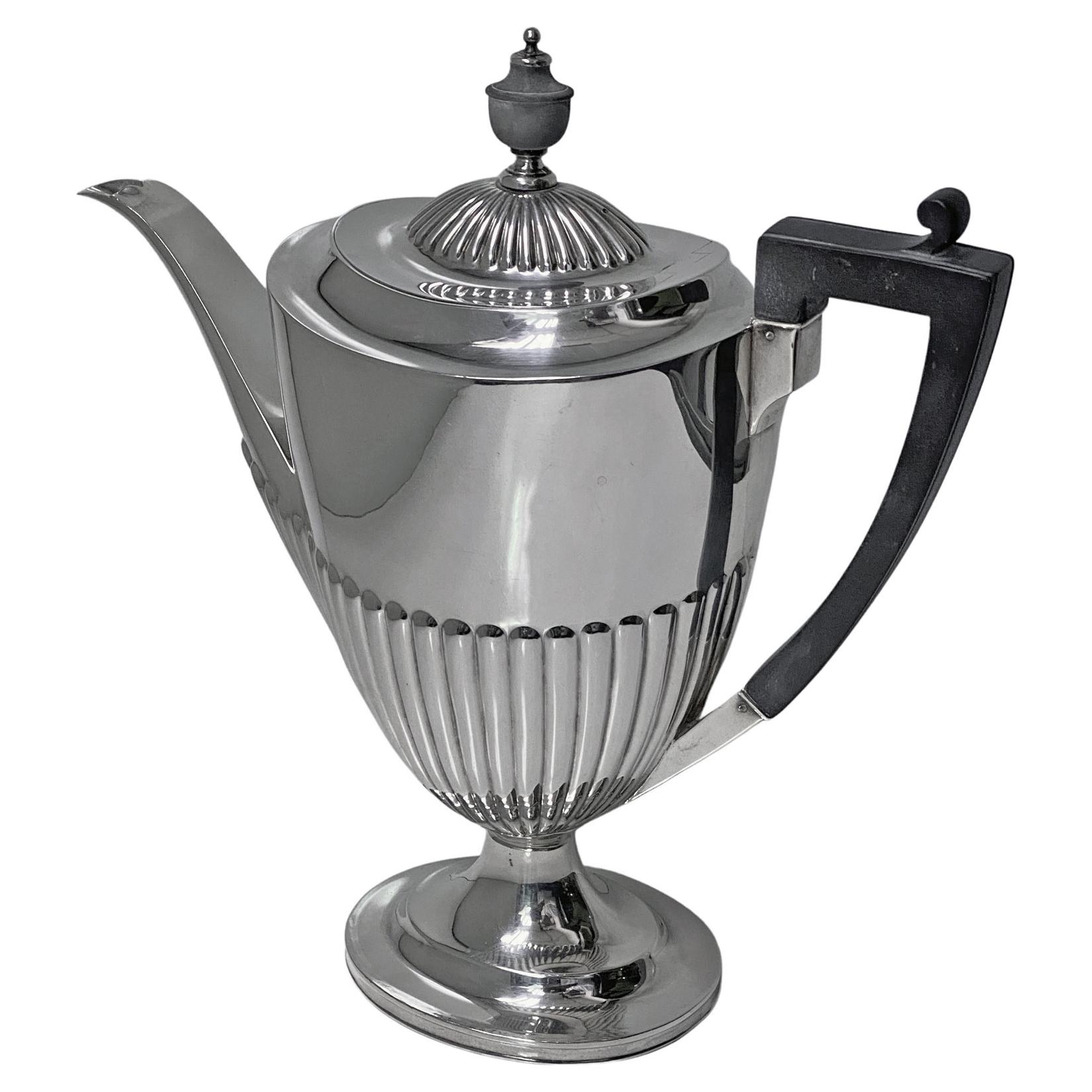 Antique Silver Coffee Pot, London 1908, Goldsmiths & Silversmiths Co. The Jug of Georgian style, on oval plain pedestal base, lower fluted vase shape body, upper body plain, hinged cover with mushroom fluted design, plain silver and wood finial,