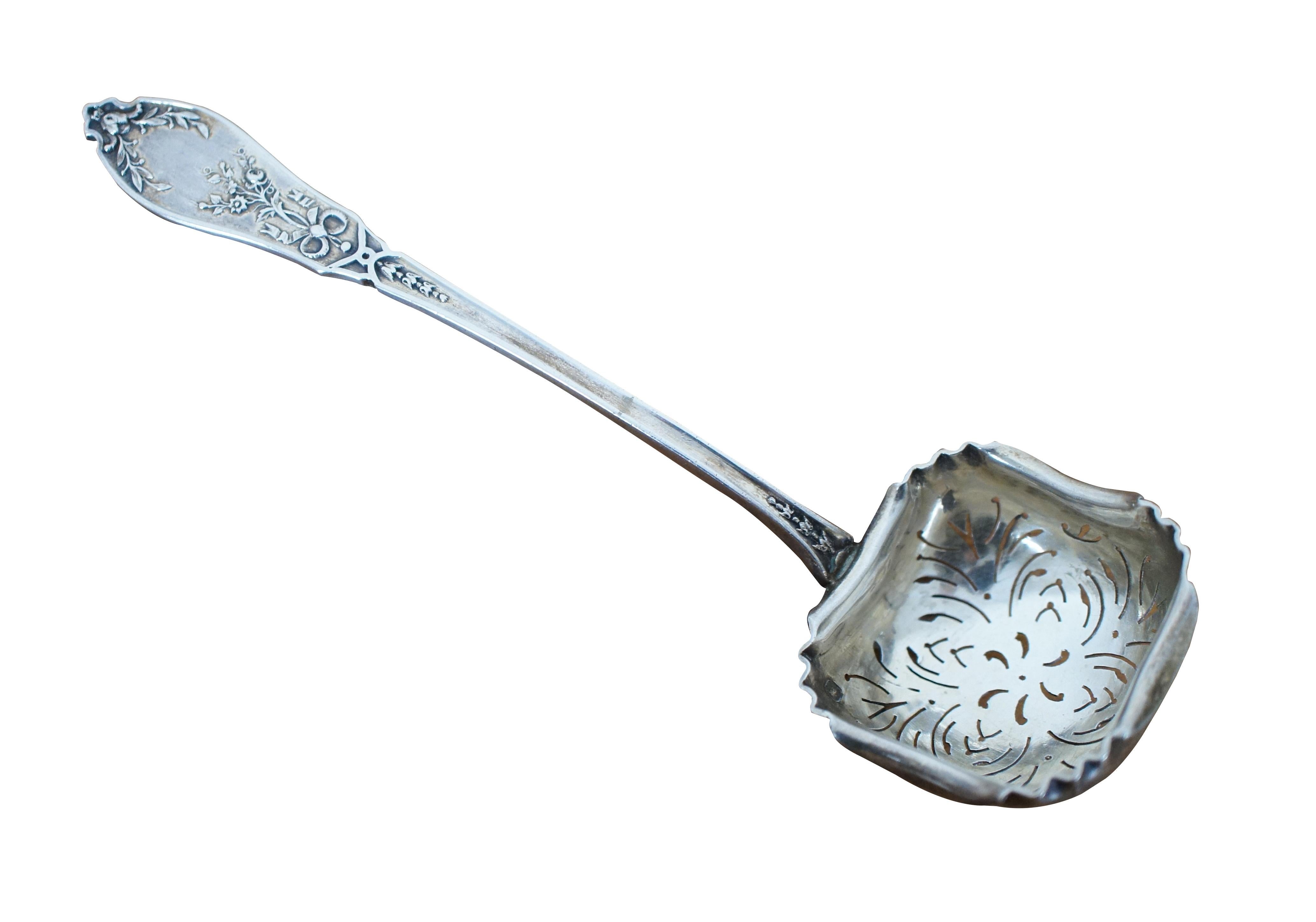 Antique silver pea spoon / tea strainer featuring a ladle shaped pierced bowl with lightly crimped edges and floral monogrammed motif on the handle. 

5.875” x 1.625” x 0.625” (Length x Width x Height) / 31.3 g.