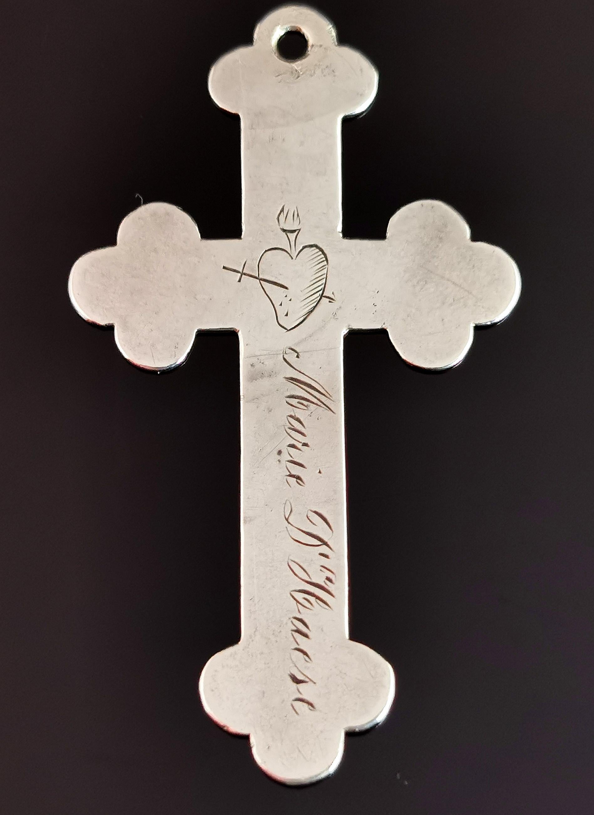 A beautiful and unusual antique sterling silver Cross pendant.

A fairly large sized cross with decorative rounded edges, it is lightweight and quite slim.

The front of the cross is inscribed with a date of 2nd Feb 1907 and has a crowned heart