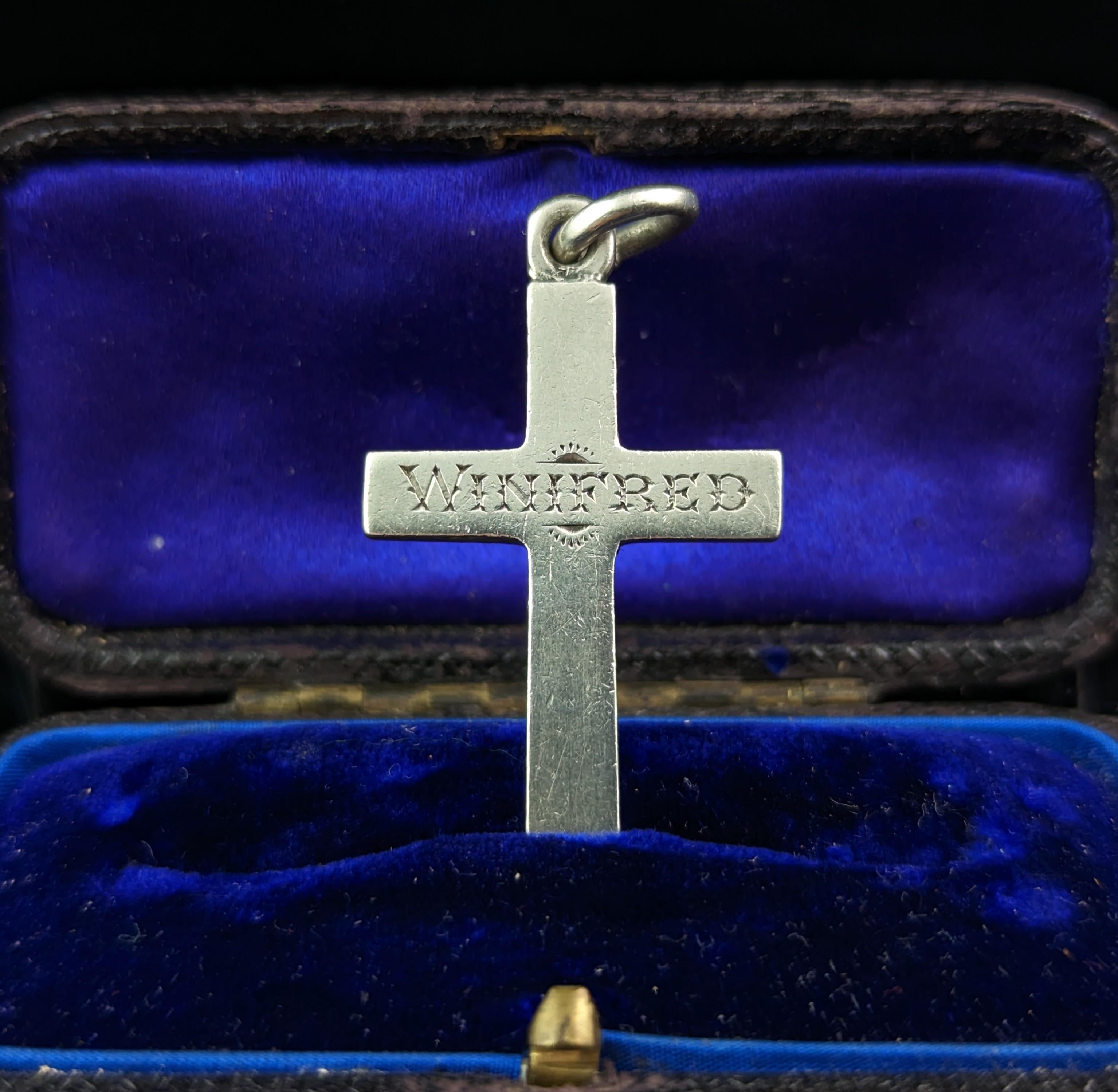 A beautiful antique Victorian sterling silver Cross pendant.

A small to medium sized cross with a polished front, fully hallmarked on the reverse and with an inscription or name to the front, nicely engraved Winifred.

This was most likely a