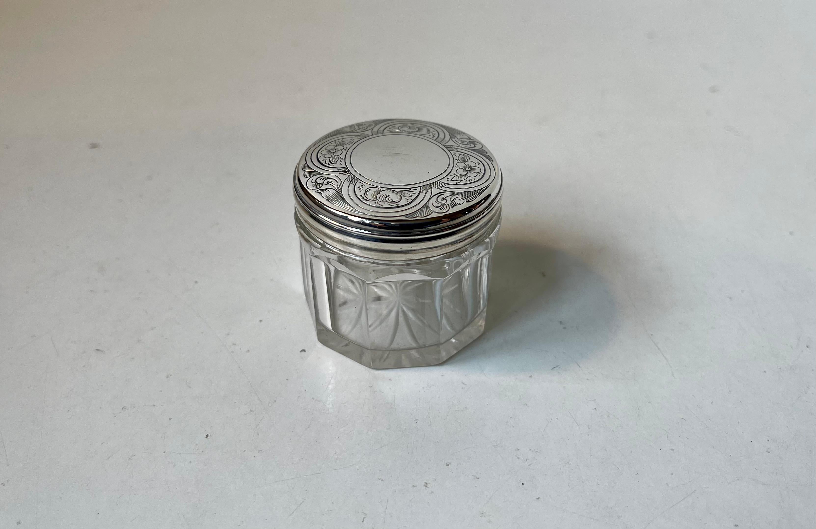 Small decorative jar, box or trinket for vanity smalls. Its executed in faceted crystal and has a silver hand-engraved lid. London Hallmarks for Thomas Wallis, Lion for solid silver and a small t for the year 1834. Measurements: D: 4 cm, H: 3.5 cm.