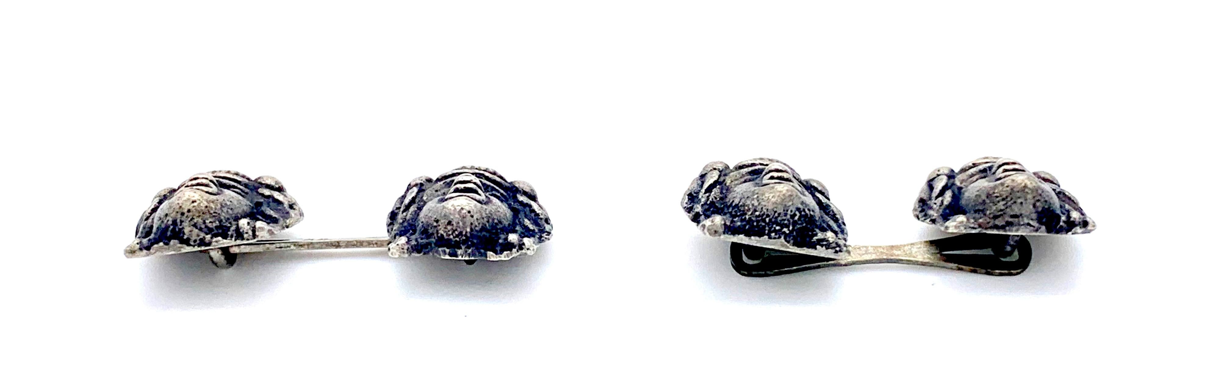 These cufflinks were made around 1900 and are made up from miniature copies of Greco-Roman theatre masks cast out of silver. The cufflinks are impressed with Austrian hallmarks and 800 for silver content. 
The measurements apply to one mask only.