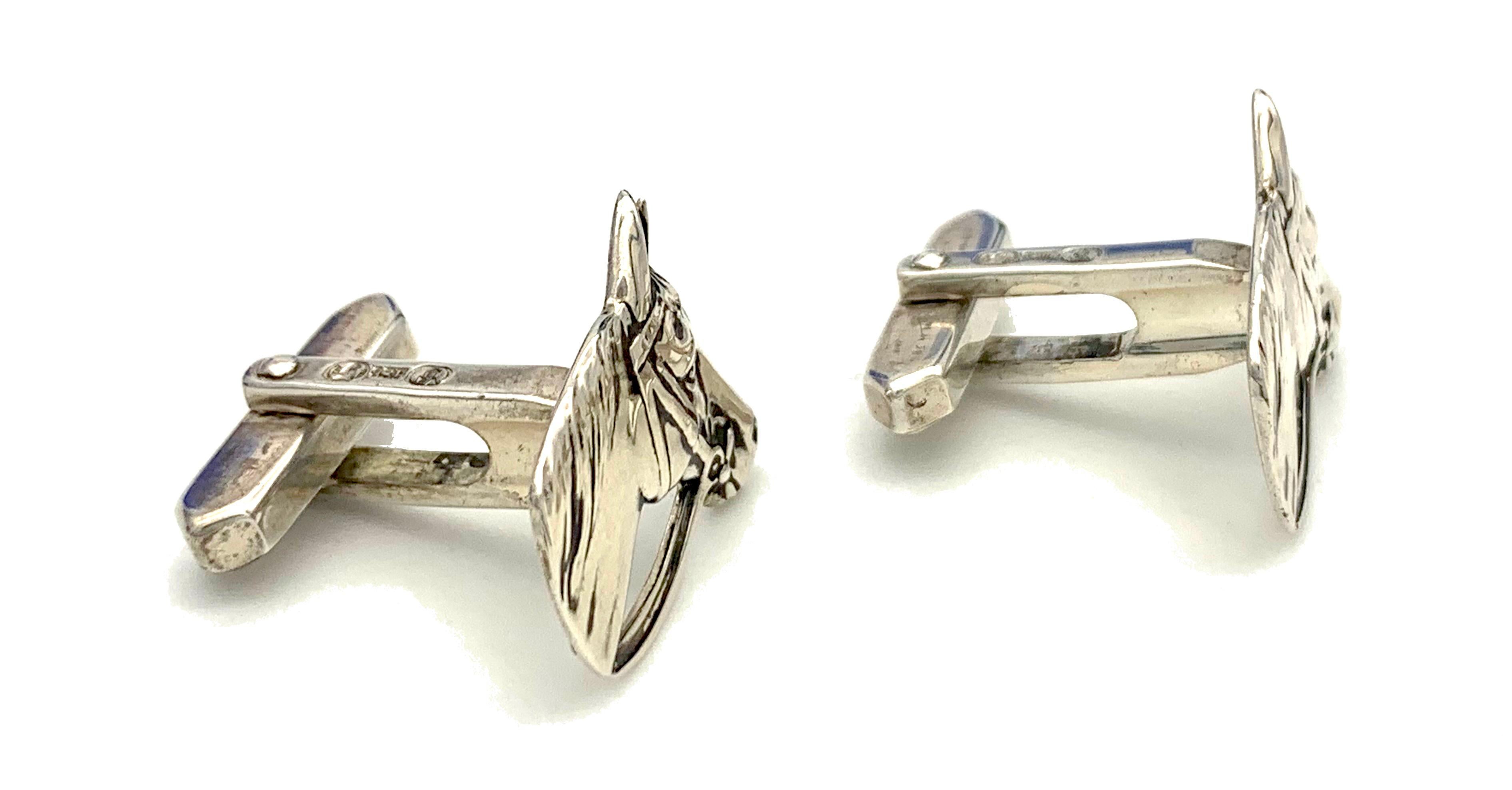 These cufflinks feature finely modelled horse heads and are made out of silver. The cufflinks are marked with the French double crab mark and are impressed 835. There is a maker's mark in an oval frame featuring a billy-goat with the letter G to its