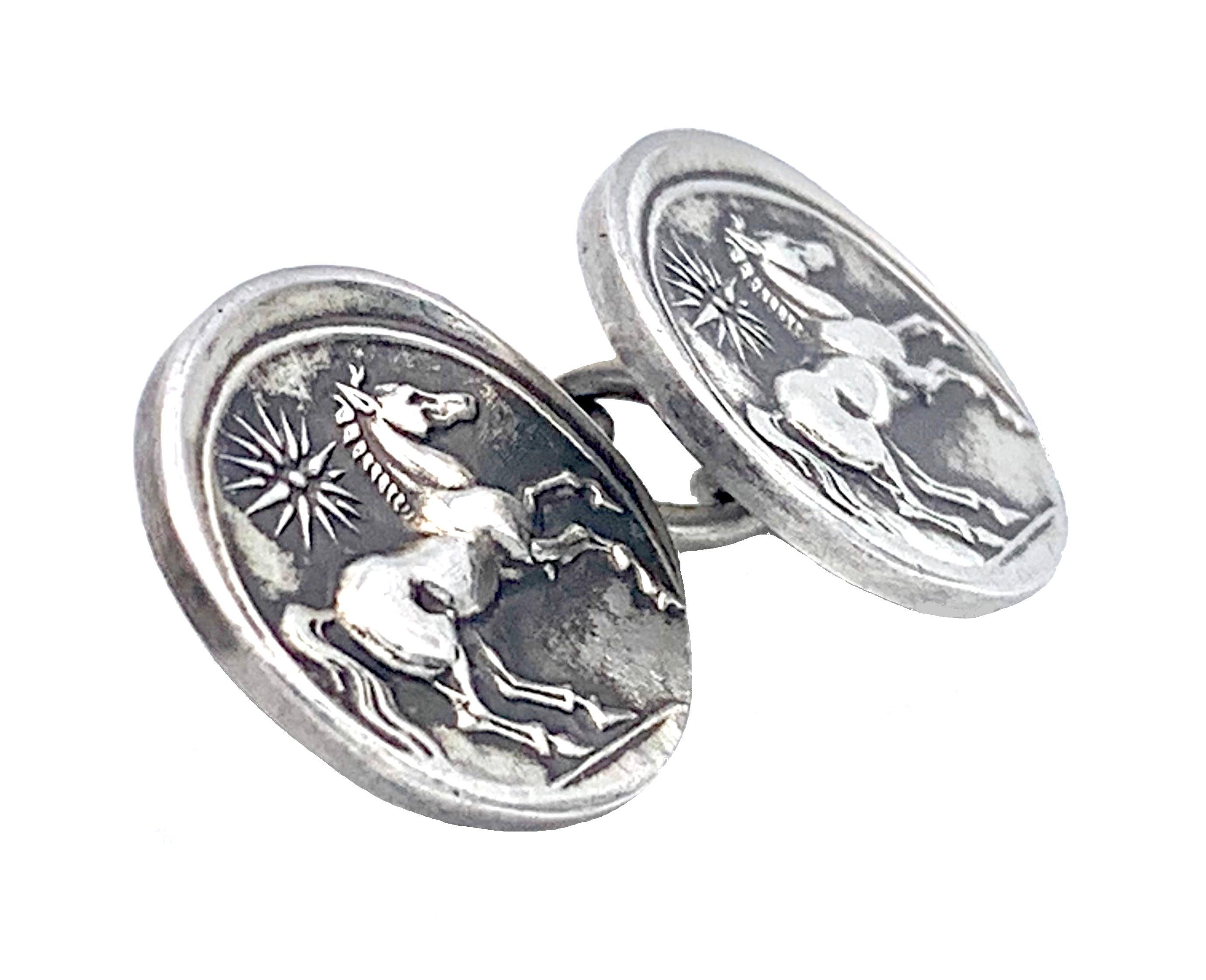 These charming cufflinks feature on each button a horse in motion and a radiant sun above it. The design may possibly have been inspired by antique greek coins. The cufflinks are impressed with unidentified hallmarks.
The dimensions cited apply to