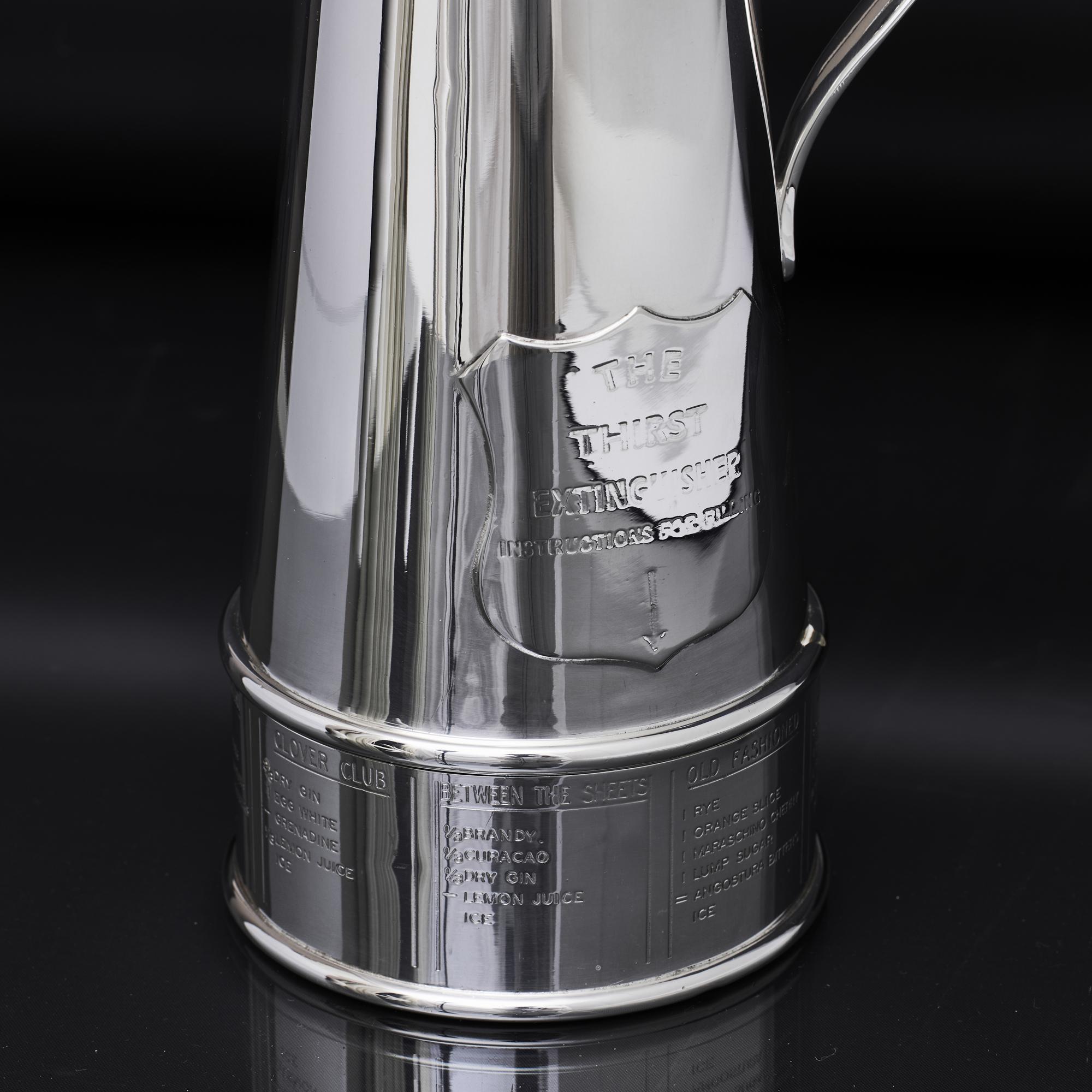 The Thirst Extinguisher is a novelty but highly useable silver-plated cocktail shaker introduced by Asprey in 1932. It is in the form of a period fire extinguisher, the base turning to reveal recipes for eight classic cocktails - Old Fashioned,