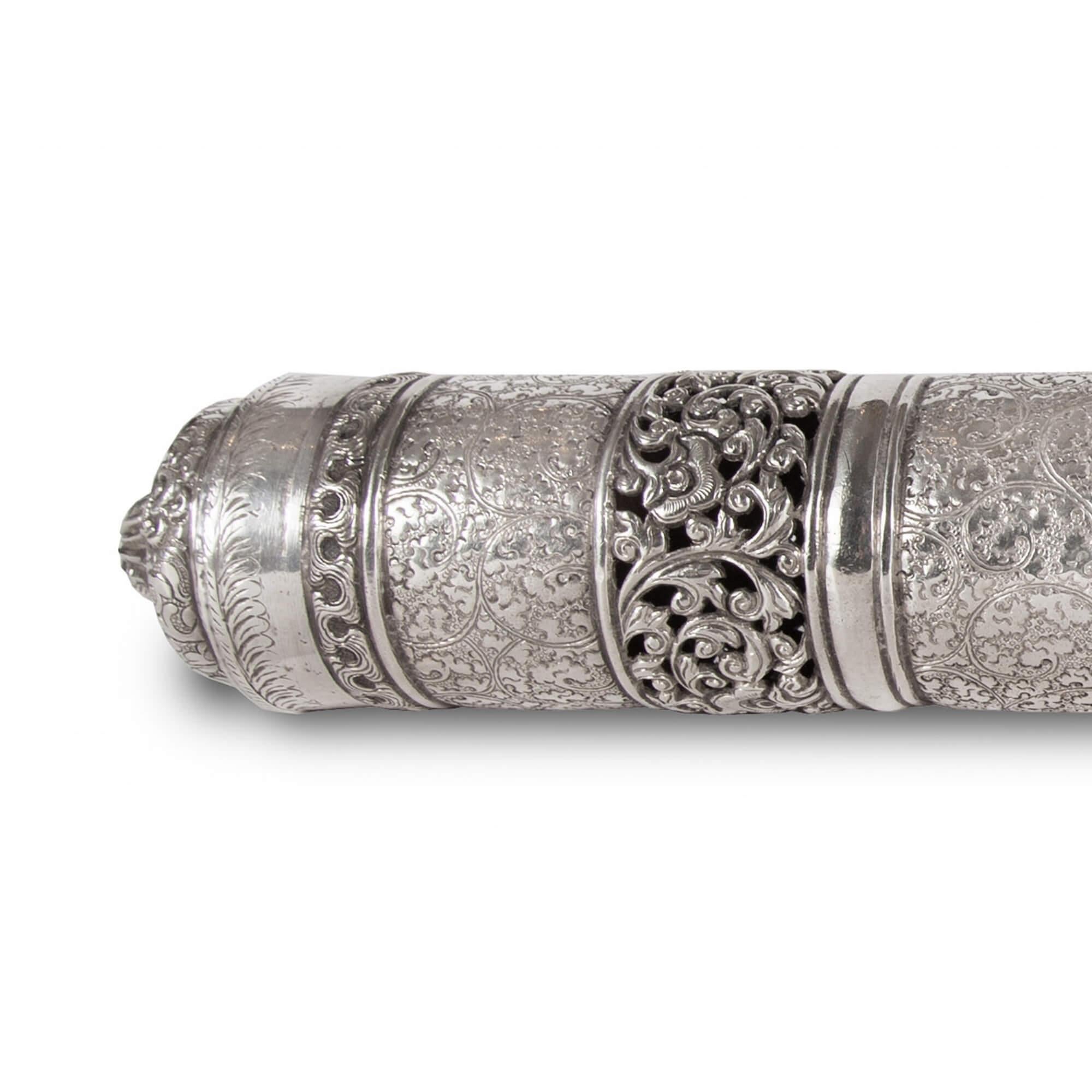 Antique silver document case from Burma
Burmese, late 19th century
Measures: Length 48cm, diameter 6cm

This wonderful object is a Burmese marriage document case. The case is cylindrical in form, and its silver surface is profusely adorned with