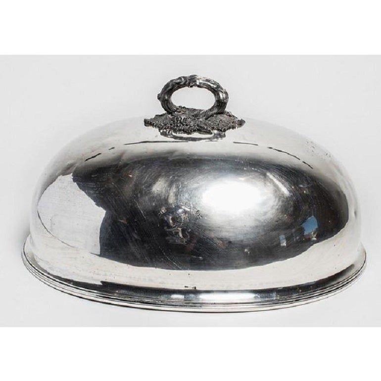 Elegant silver-plate dome dish cover with ornate handle, made in England in the 19th century.

 