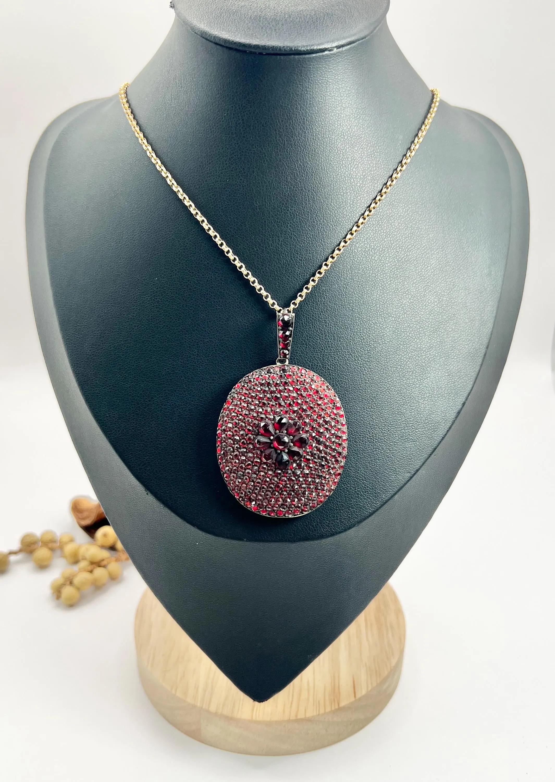 Antique Bohemian Garnet Locket

Silver Tested

Circa 1875

* THE CHAIN IS SOLD SEPARATELY 

Step into the elegance of the Early Victorian era with this stunning large oval-shaped locket, meticulously crafted in silver. Its enchanting front is fully