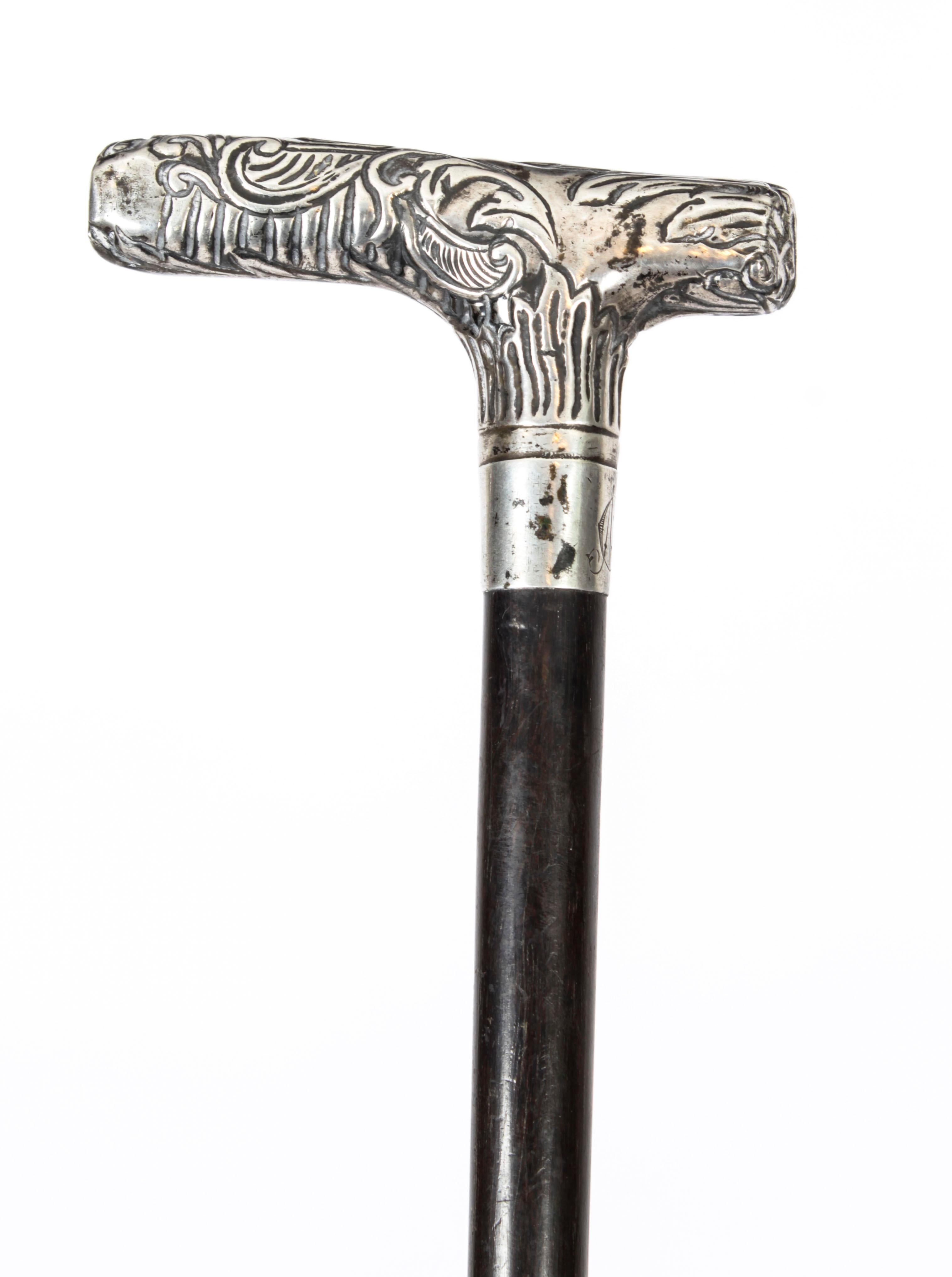 This is a fantastic antique French Art Noveau silver handled and ebonized walking stick, circa 1890 in date.
 
It has a very decorative silver lever handle decorated with foliate ornamentation which is cast with great attention to detail with a