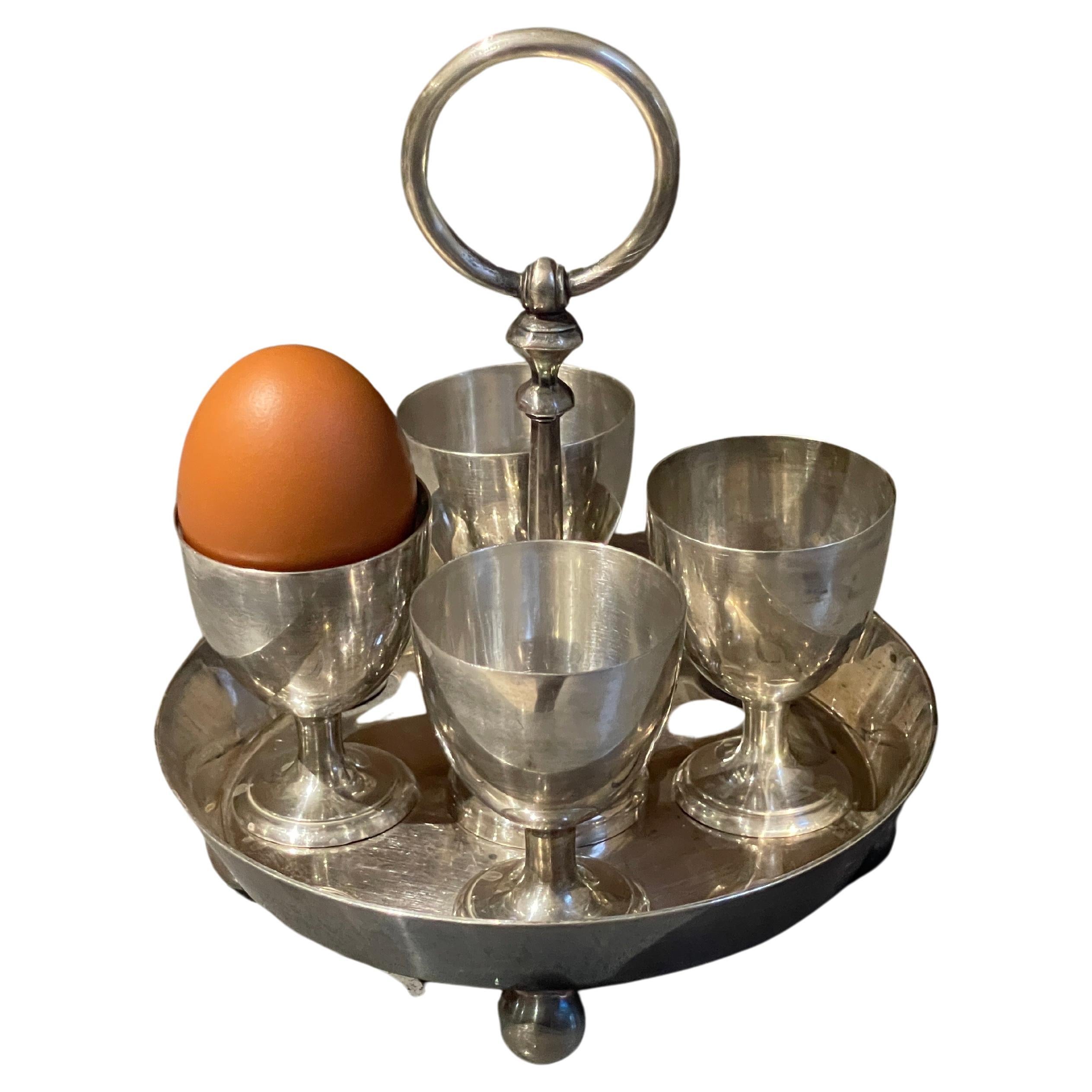 Mappling Princess Plate London and Sheffield silver egg coddler stand holder in art deco style from 1880 with four silver egg holders with four silver spoons. Four silver-plated spoons accompany it. The pierced egg holders measure 2 1/3'' in height