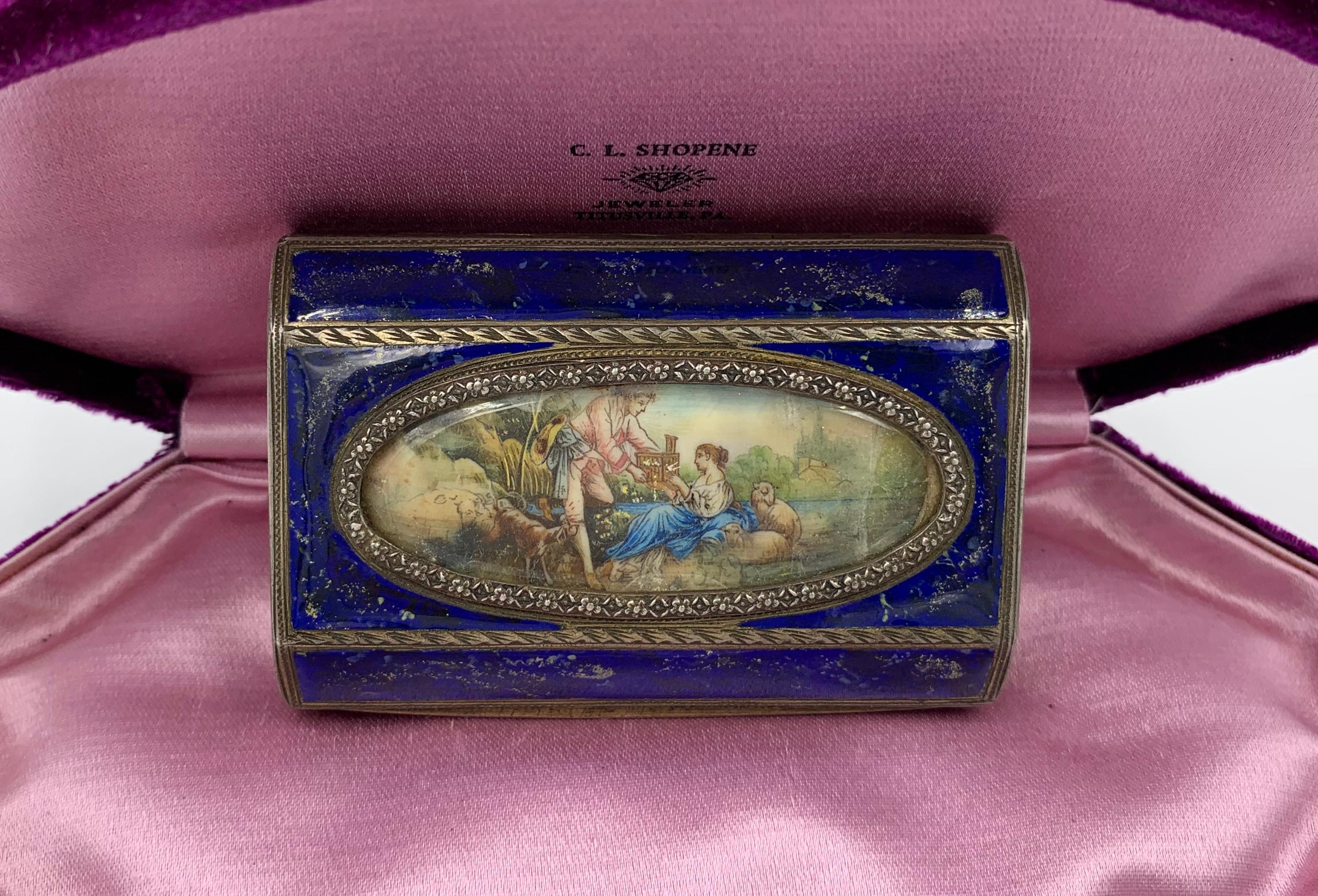 A stunning antique Victorian box decorated with Royal Blue Enamel with gold flecking throughout creating a Lapis Lazuli effect.  In the center of the box is a very special hand painted miniature painting.  The painting depicts a pair of courting