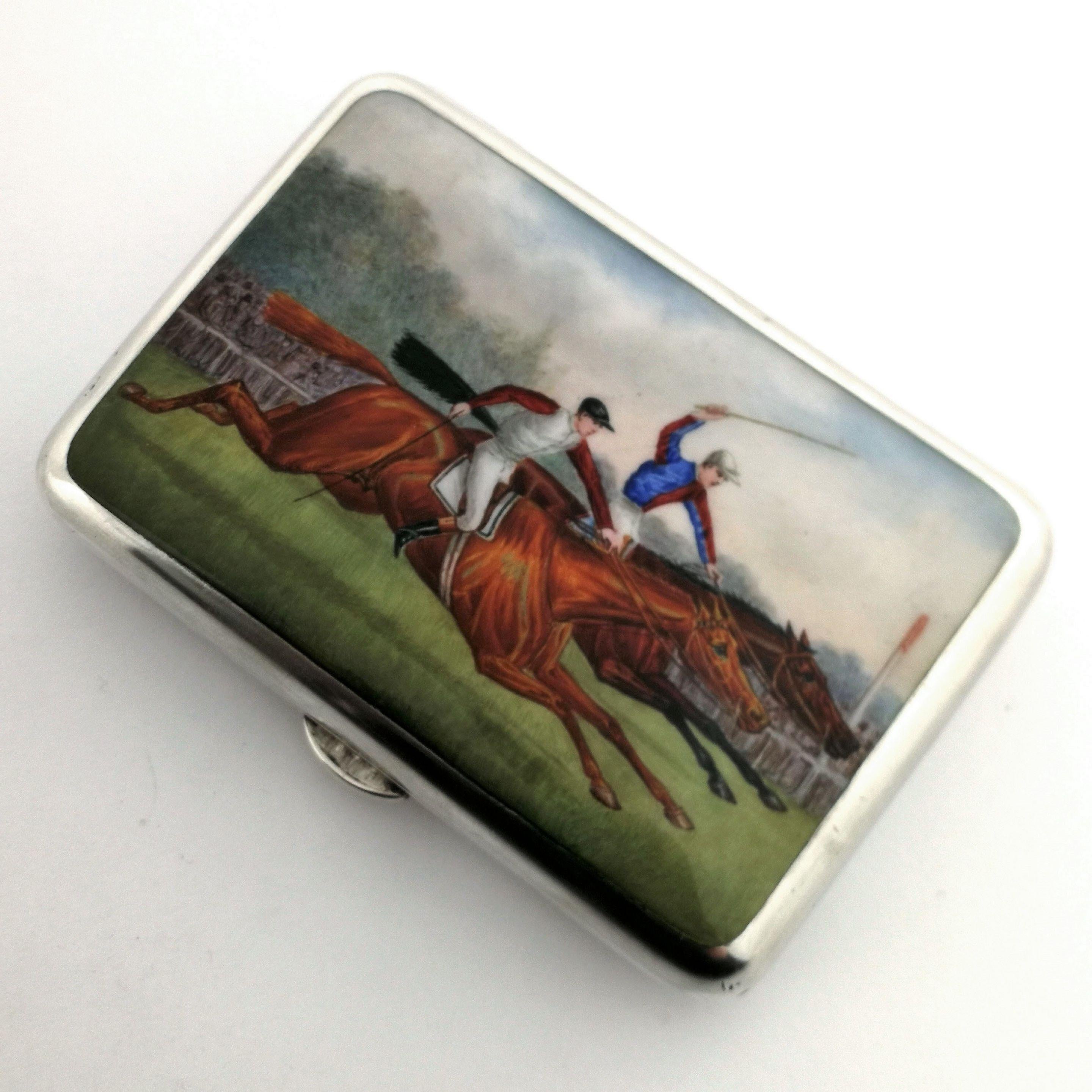 A gorgeous Antique Victorian sterling Silver and Enamel Cigarette Case. The cover of the case features a richly coloured enamel image of a pair of horses and jockeys racing down a grass track. The interior of the Case has a pair of engravings -