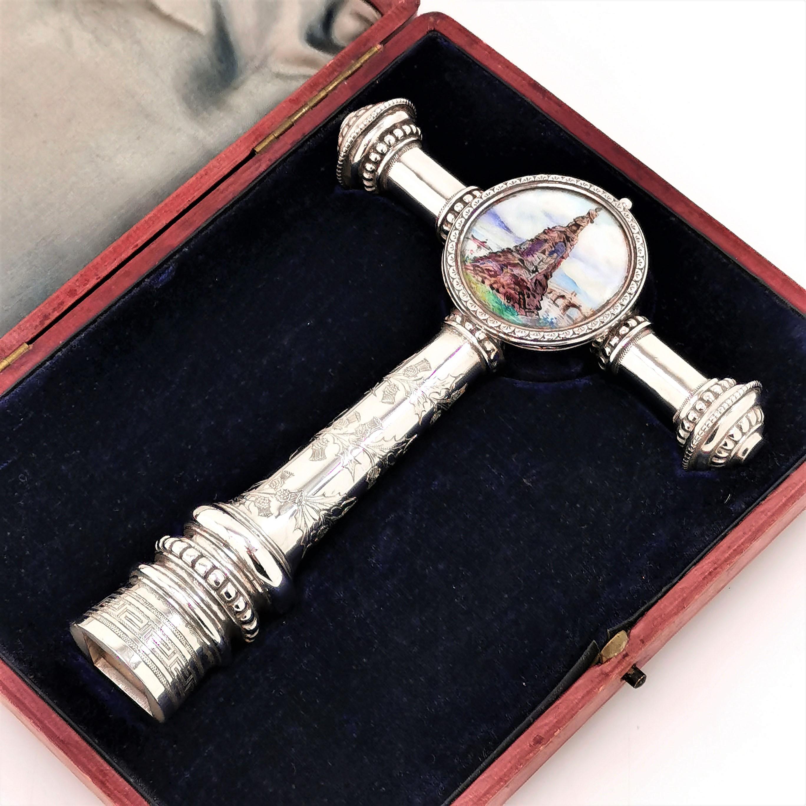 A wonderful, unusual Antique Silver Presentation Key with Enamel Detailing presented in its original fitted case. The Enamelled Cartouche shows a classical figure on top of a rock base. The back ground shows a river with a rower and a bridge.

The