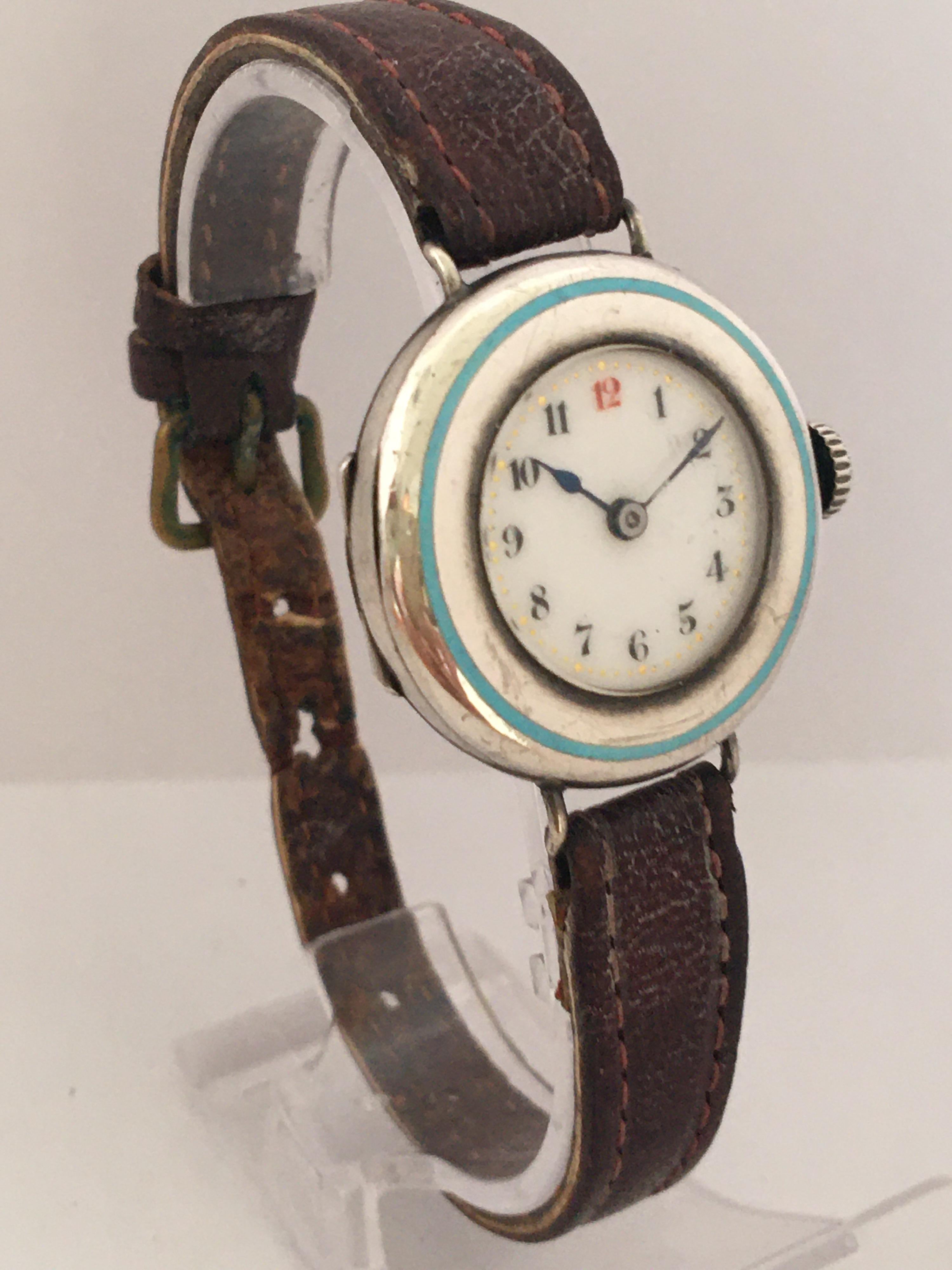 This beautiful pre-owned silver enamel manual winding  trench watch is working and is ticking well. Visible signs of used and ageing with minors scratches and tiny dents on the silver case and the strap is worn as shown.

Please study the images
