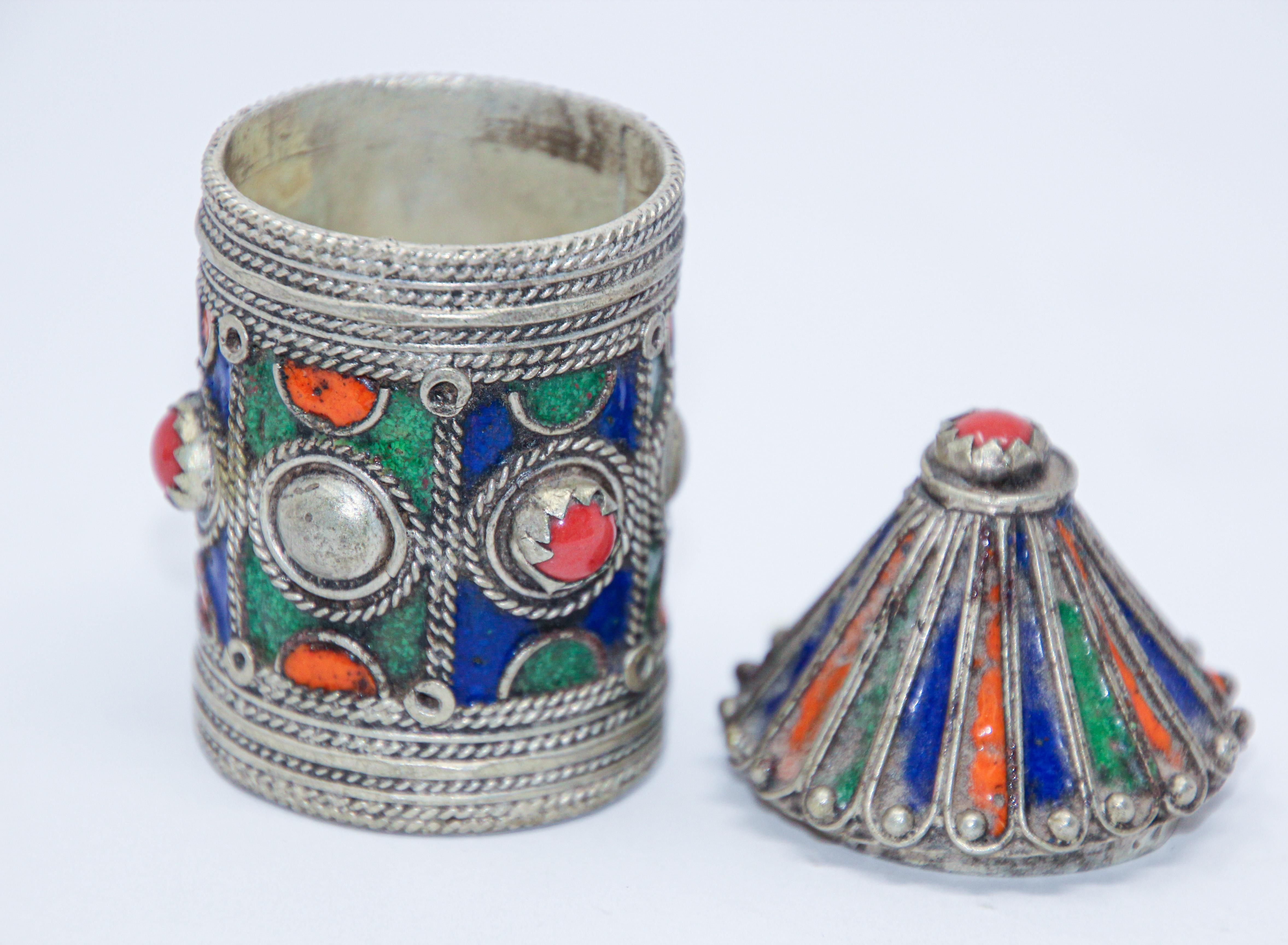 Antique Berber Kabyle box container to hold loose powder kohl eye liner.
Made of silver wash with filigree enamel in pagoda shape.
Enamel and rhinestone made of silver tone metal with filigree scales and applied enamel in red, green, orange and