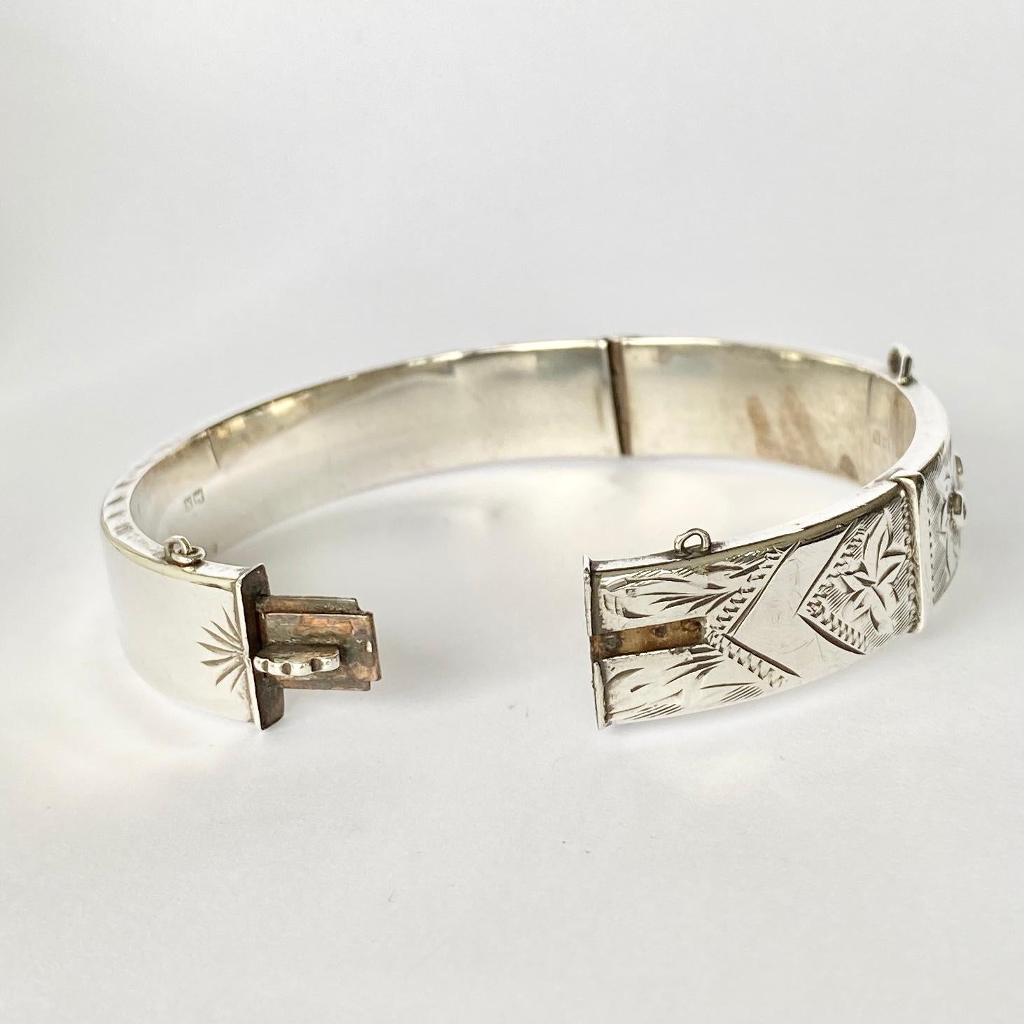 Deeply and intricately engraved on the front panel of this bangle is a classic swirl and textured design and a delicate buckle. Hallmarked Birmingham 1937. 

Inner Diameter: 60mm
Bangle Width: 14mm 

Weight: 20.2g