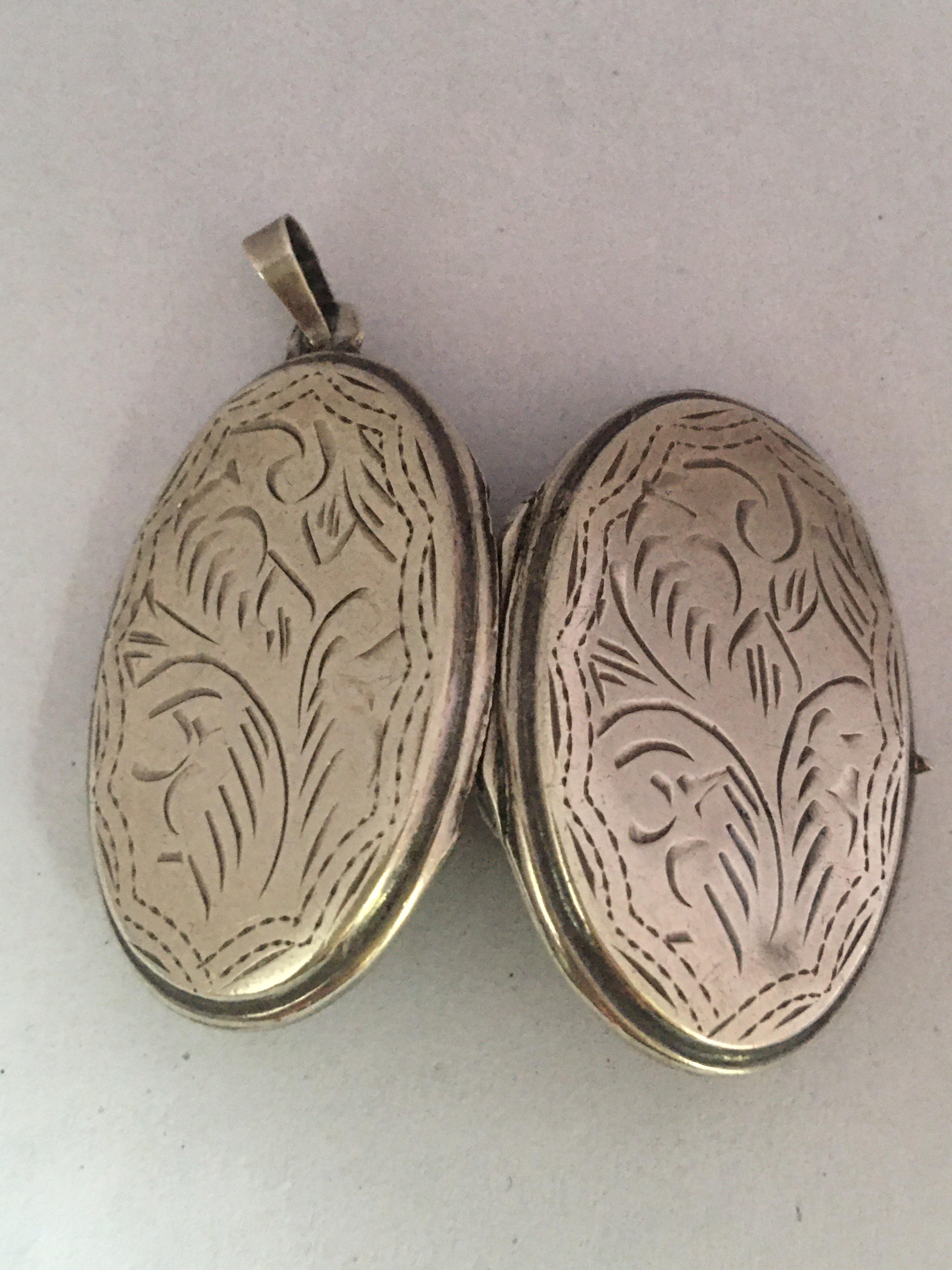 This beautiful antique silver oval locket pendant is in good condition. Visible signs of ageing and wear with small light marks as shown.