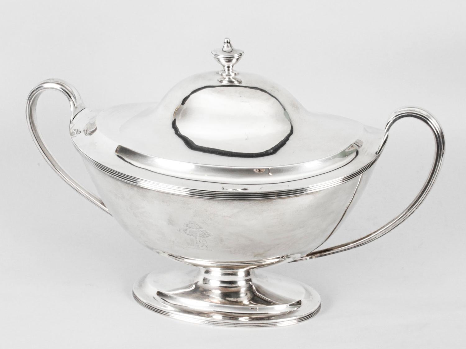 This is a beautiful antique English George III sterling silver tureen and lid, with hallmarks for London 1808 and the makers mark WB for William Bennett.

The tureen is beautiful in its simplicity.

There is an engraved crest and a fabulous coat