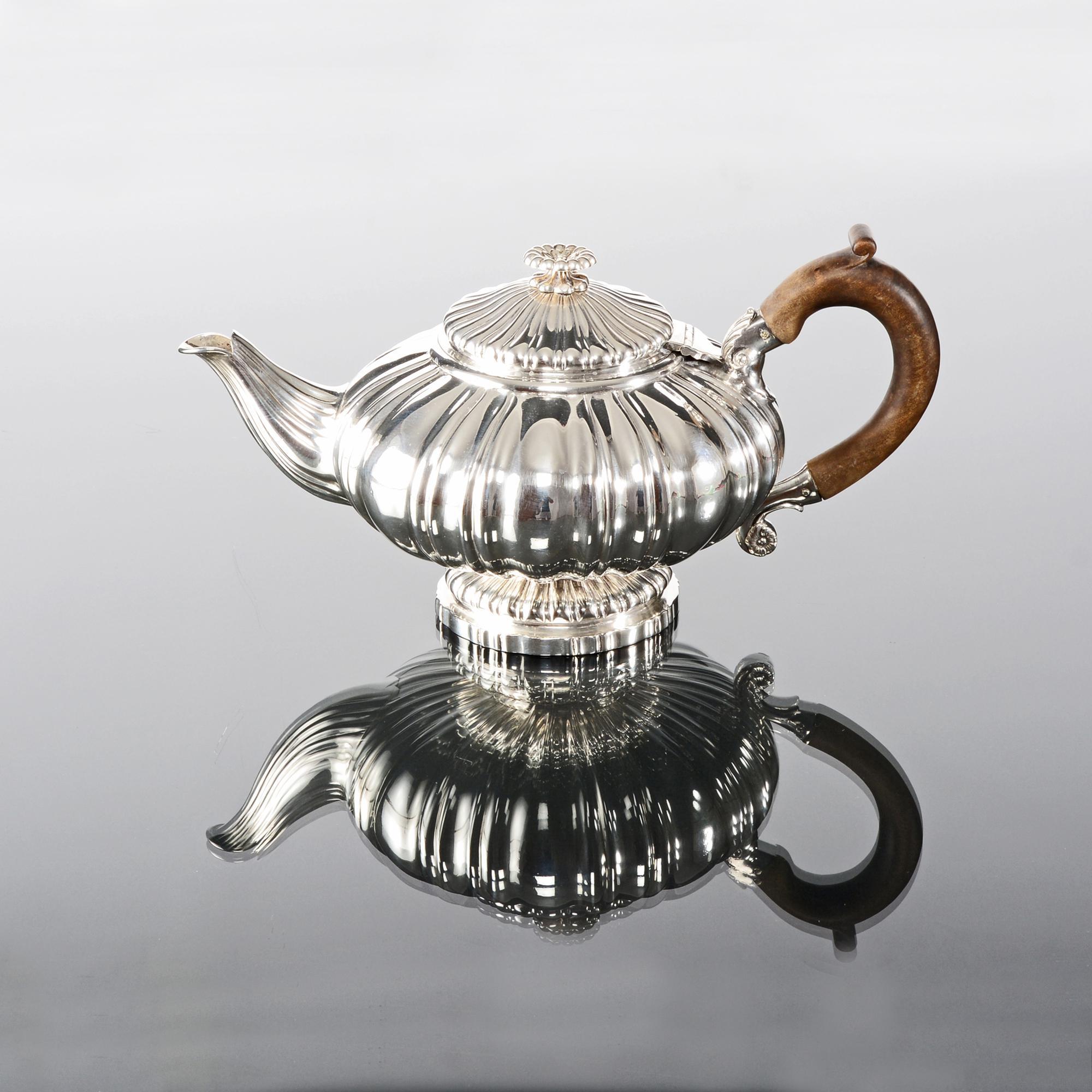 eautiful antique silver teapot, made in the first year of the reign of King George IV. The body of the silver teapot is a compressed fluted melon form and rests on a fluted and shaped circular base.

While the fluting extends to the graceful