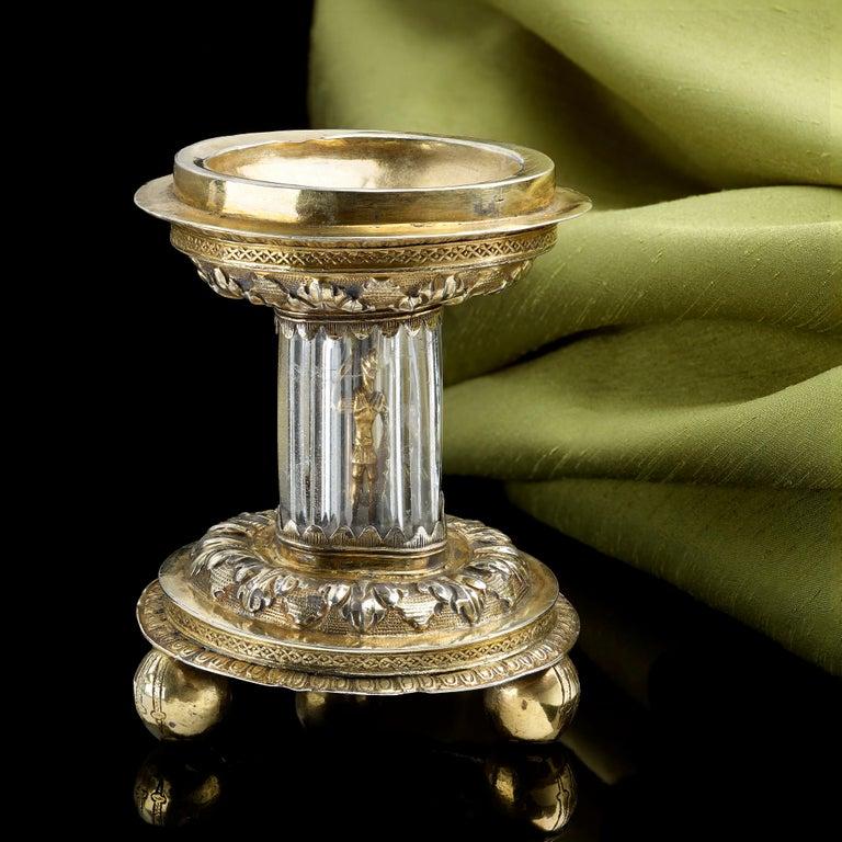An extremely rare silver gilt standing salt from the English Renaissance, circa 1550

The gilt base stands on three little ball feet. There is a central rock crystal tube inside which there is the gilt figure of Longinus, the Roman soldier who,