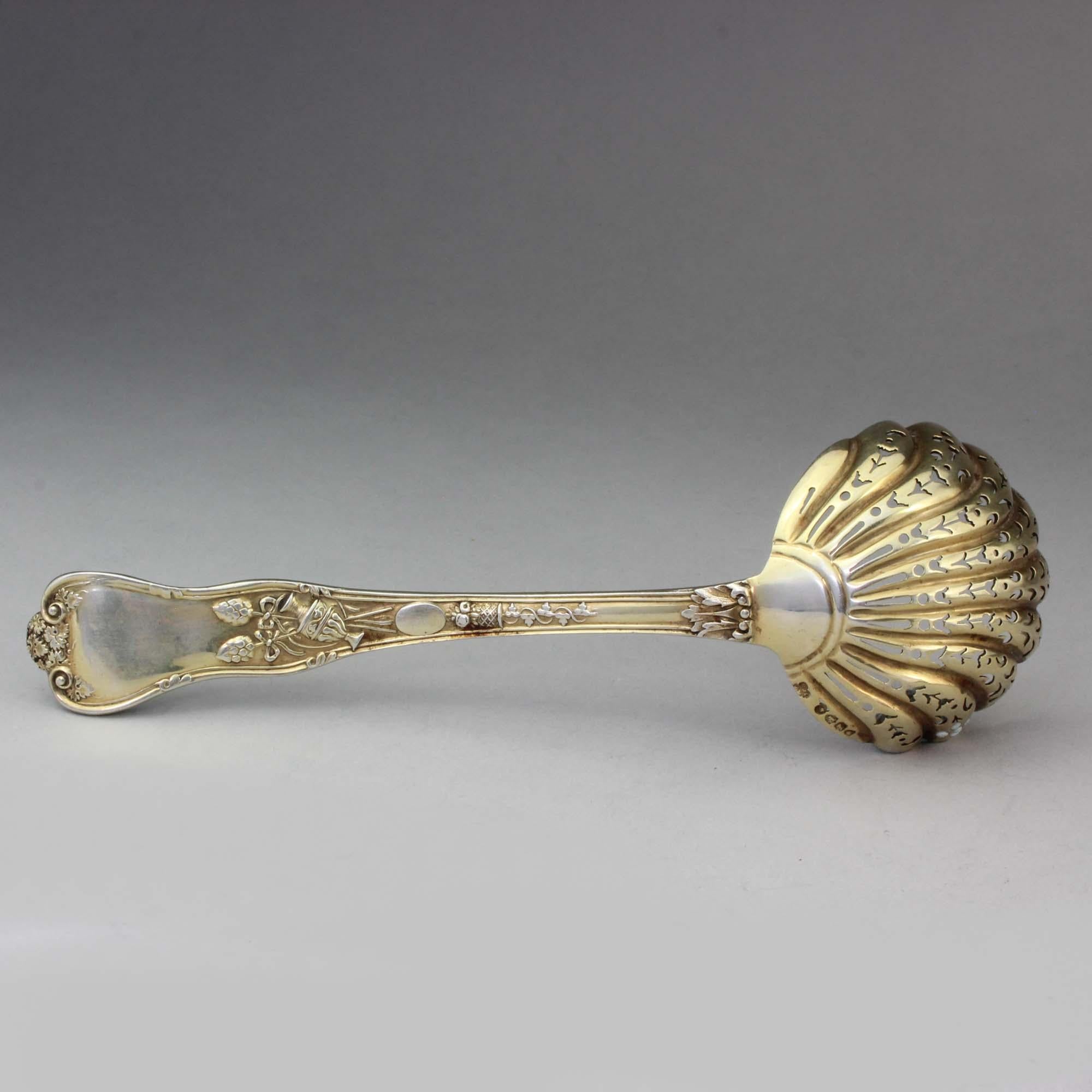 Antique silver gilt sugar sifting spoon 
The spoon has a figural decoration.

Made in England, London, 1881
Maker: Henry John Lias & James Wakely

Dimensions:
Length x width x height: 16.8 x 5.3 x 3 cm
Weight: 65 grams

Condition report: