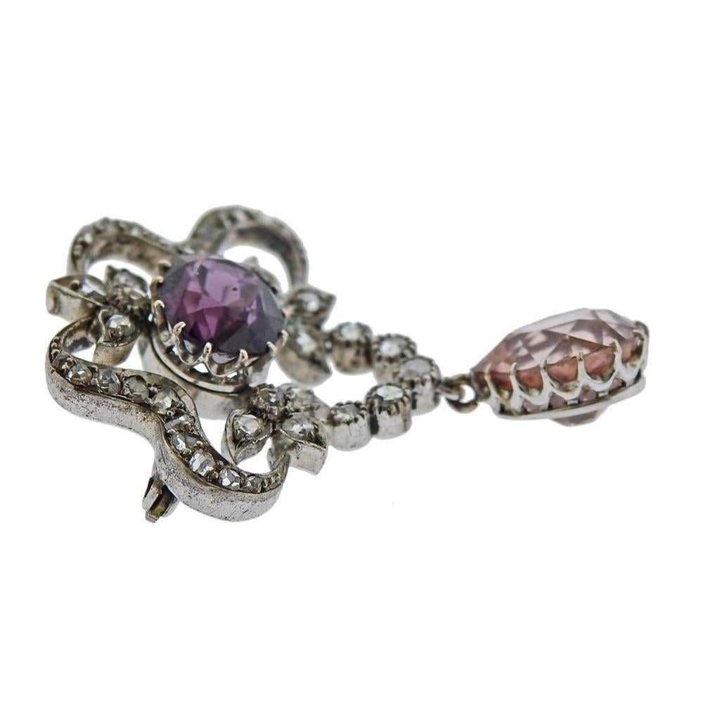 Antique 14k gold and silver brooch, set with rose cut diamonds, pink Imperial topaz  (measures  approx. 10.7 x 8.2 x 6.15mm ) and a purple gemstone (approx. 9.25 x 7.8 x 5.9mm). Brooch measures 38mm x 28mm. Tested 14k and diamonds are sent in