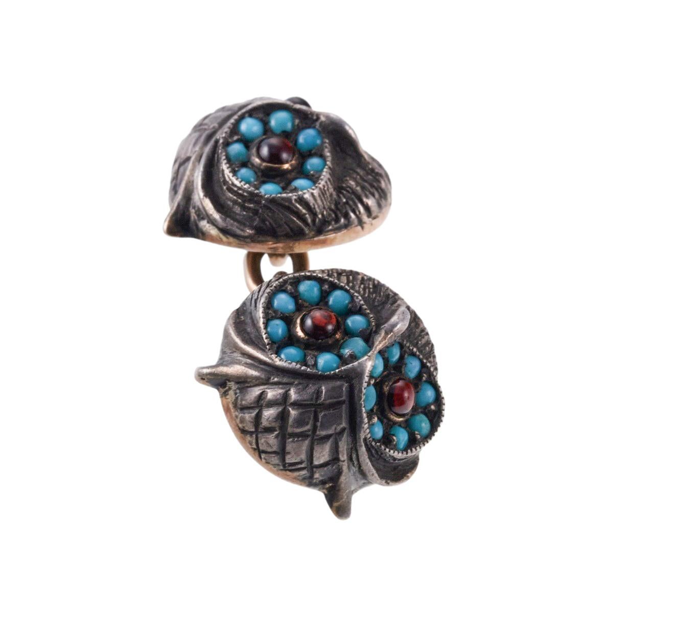 Pair of antique silver top and gold back owl cufflinks, set with garnet eyes and turquoise. Each top measures 12mm in diameter. Weight of the pair - 9.9 grams. 