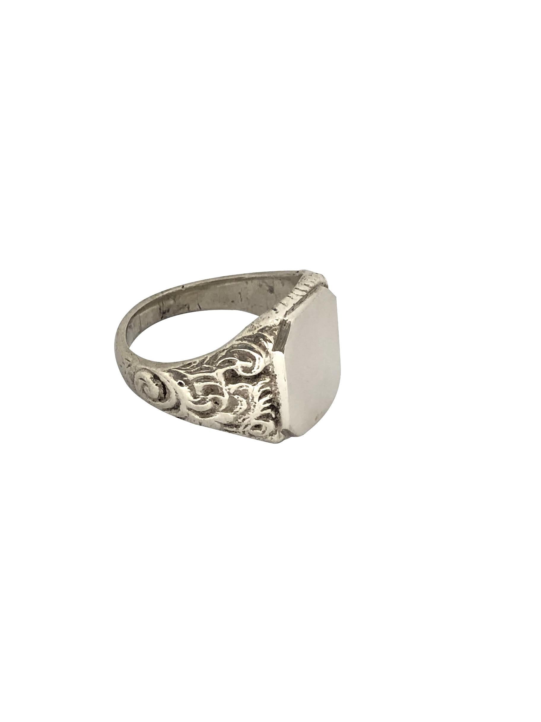 Circa 1900 - 1910 800 Silver Signet Ring, having heavy detailed Chased sides, the un engraved top measures 5/8 X 1/2 inch, finger size 11 1/2 and can be sized if needed. 
