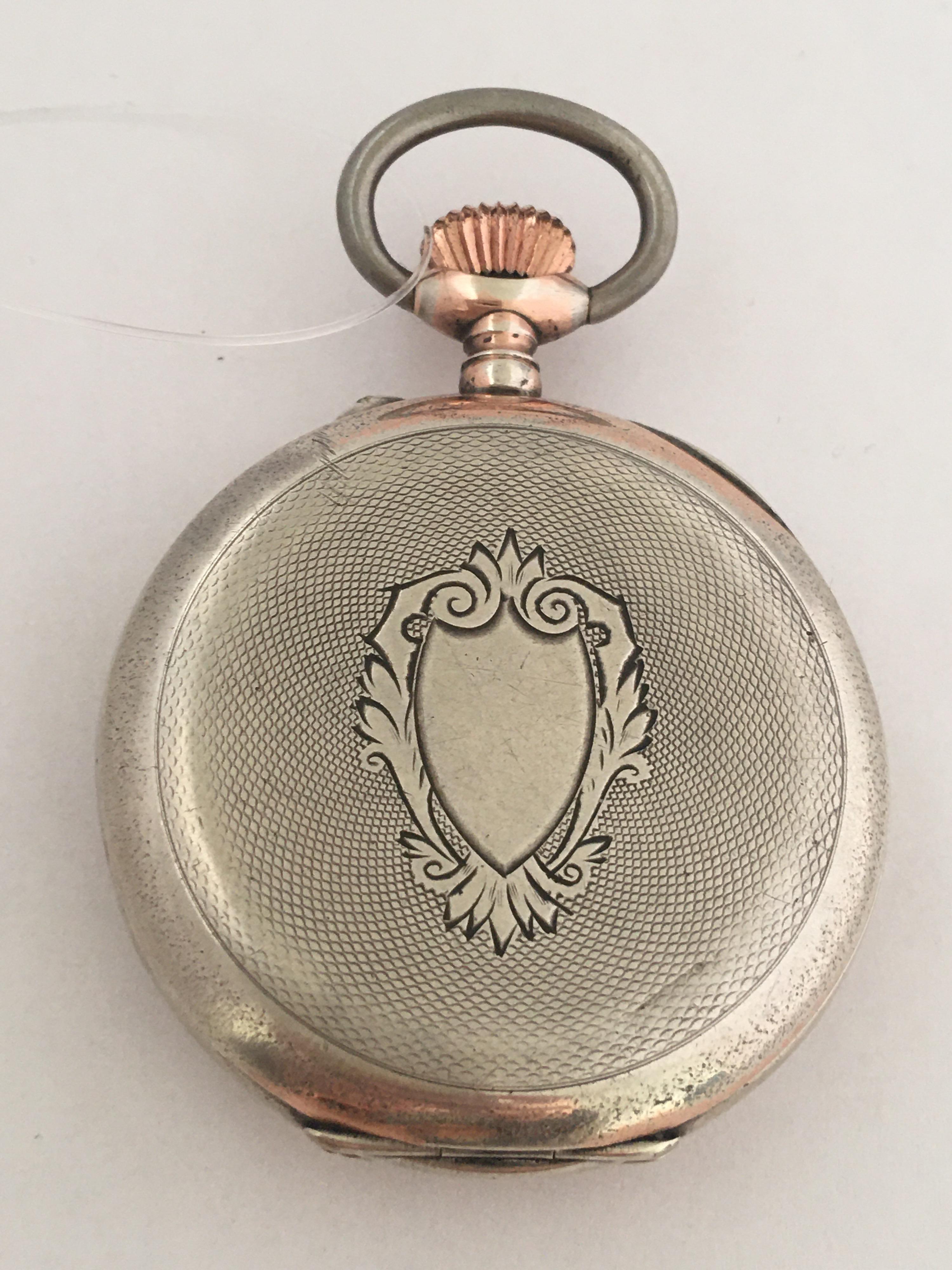 This beautiful antique silver pocket watch is in good working condition and it is ticking well. Visible cracks & chipped on the enamel dial and some tiny scratches & dents on the back cover case as shown. Watch is 47mm Diameter 

Please study the
