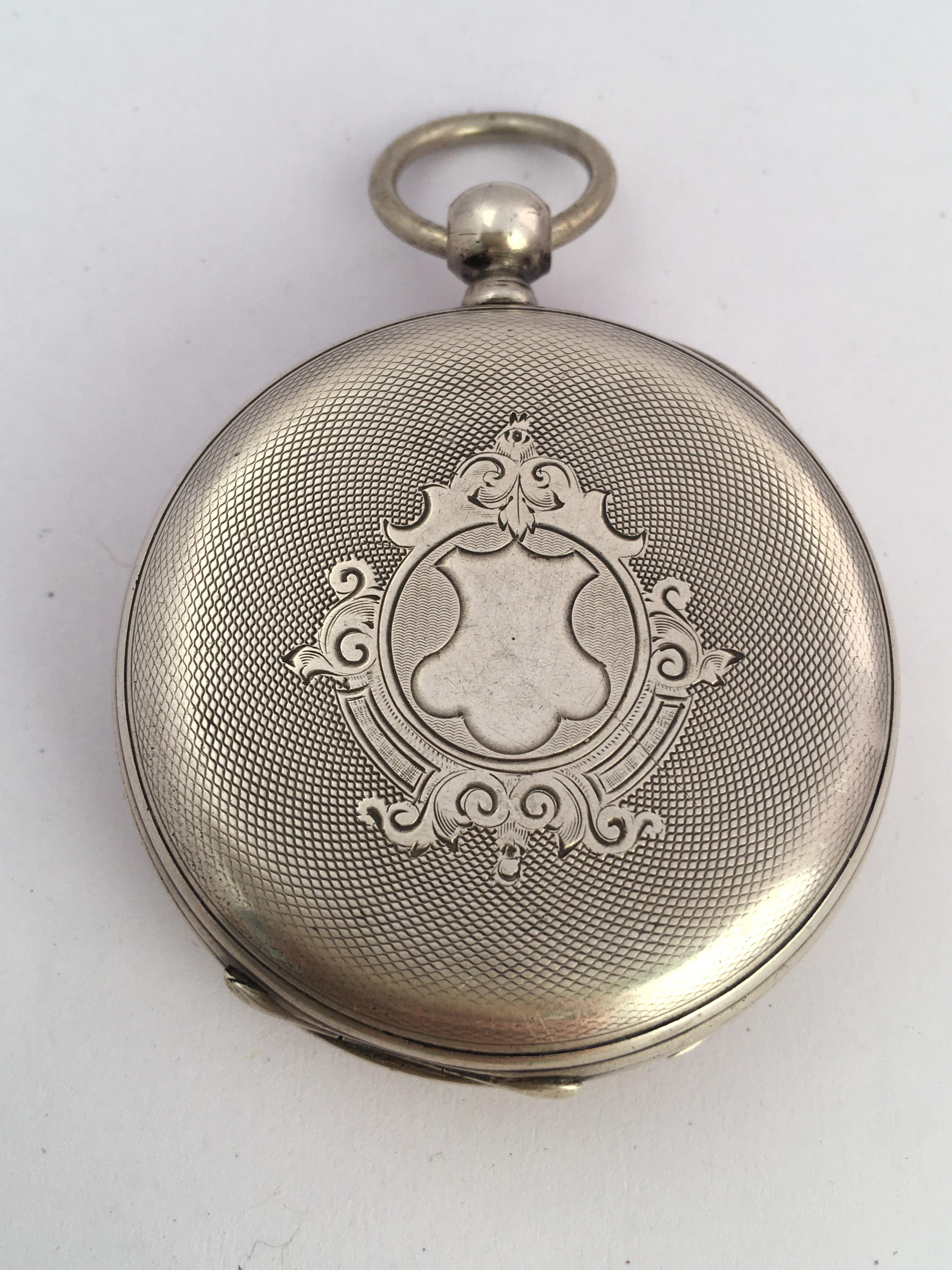 This beautiful antique 48mm diameter hand winding silver pocket watch is in good working condition and it is running well (It keeps a good time). Visible signs of ageing and wear with small light marks on the glass and on the watch case. A tiny