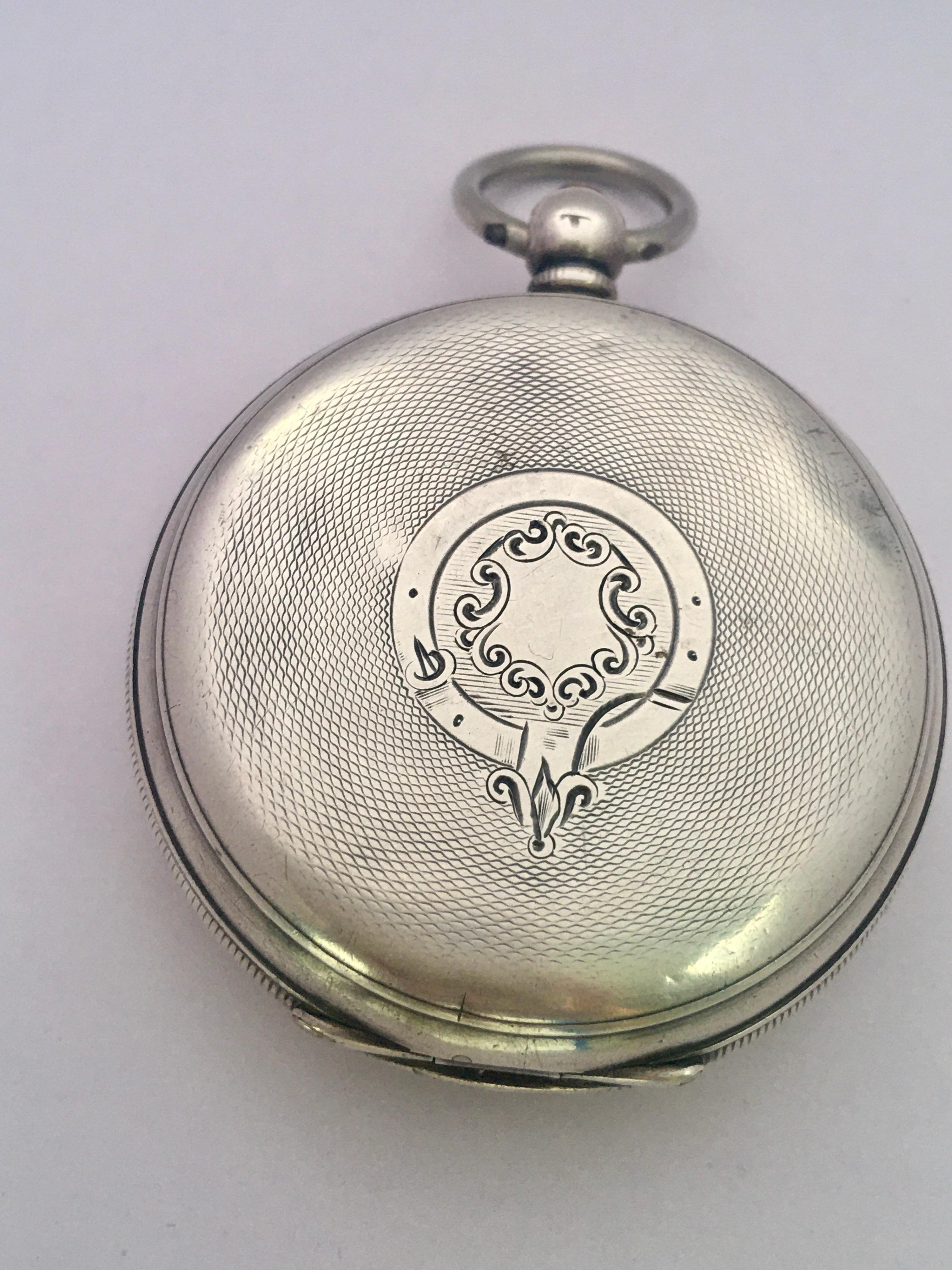 This beautiful 51mm diameter (excluding crown) key winding silver Pocket watch is in good working condition and it is ticking. It is recently been serviced and runs well. Visible signs of ageing and wear with light scratches and dents on the silver
