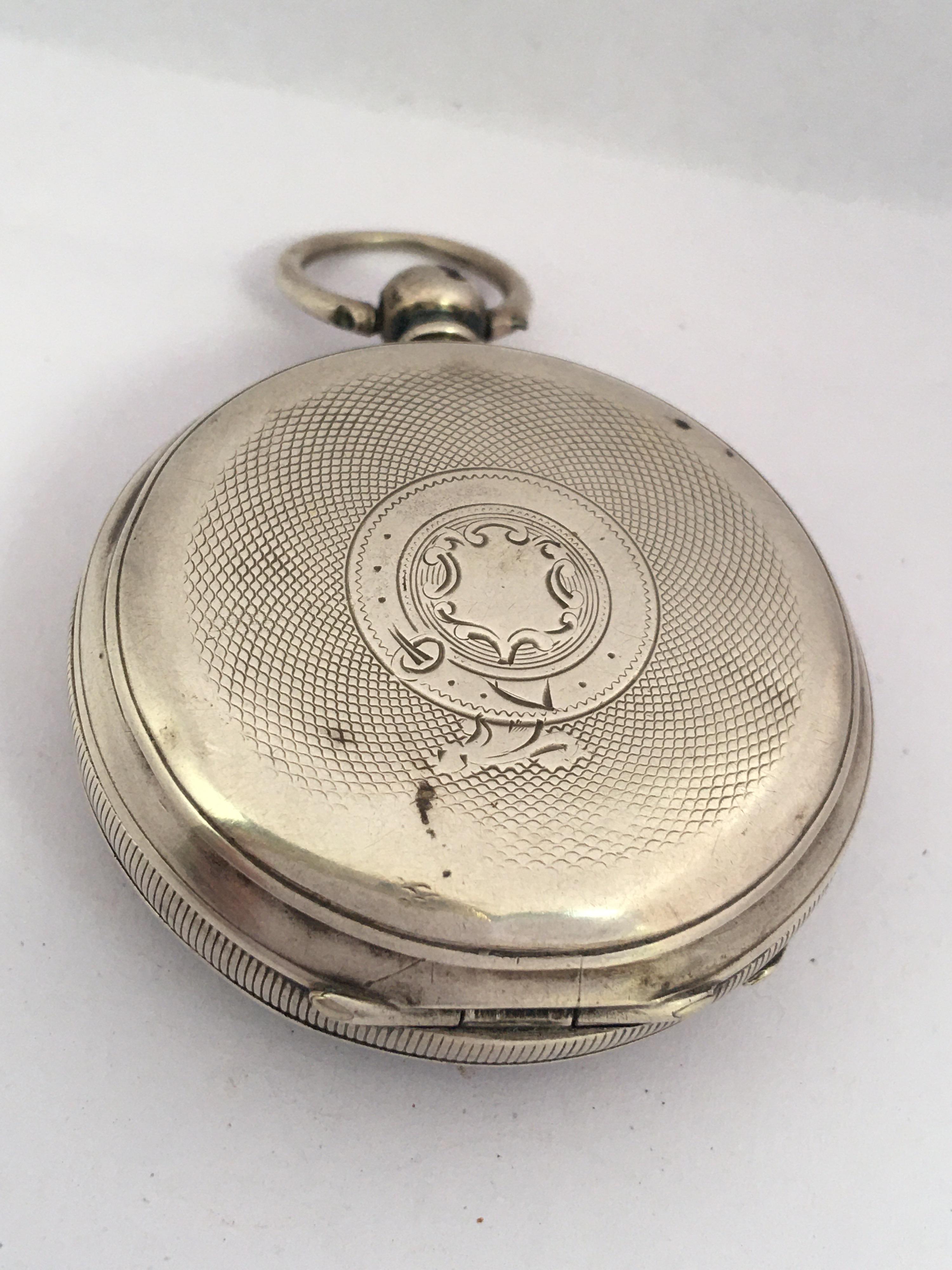 This beautiful antique 49mm diameter key winding silver pocket watch is in good working condition and it is running well. Visible signs of ageing and wear with light marks on the glass and on the watch case as shown. Some dents on the silver watch