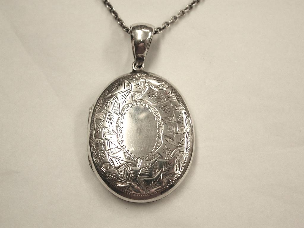 Antique Victorian Silver Locket,Birmingham, 1884 on Old Silver Belcher Chain
Nicely engraved on front with ivy decoration on 23 Inch Old Silver Chain