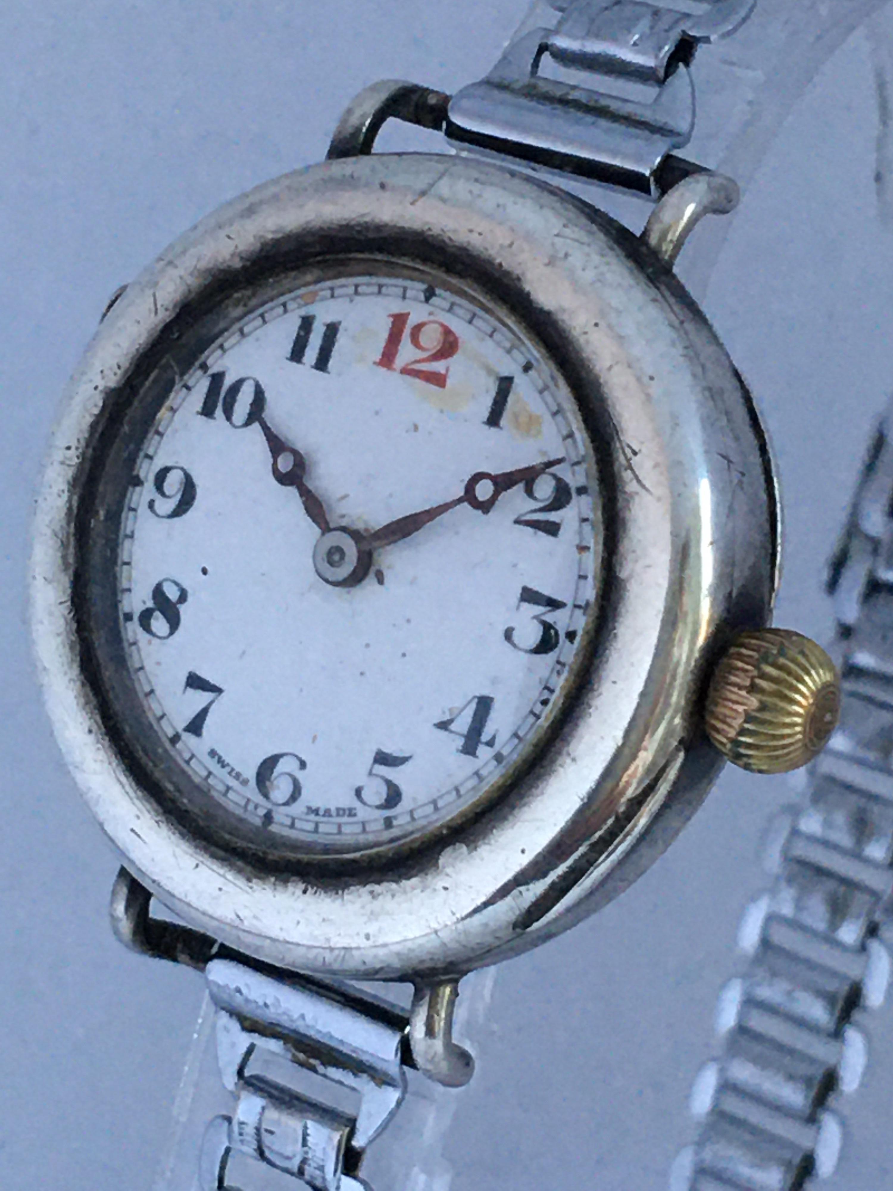 This beautiful antique silver hand winding trench watch is working and it is ticking well. The white dial is a bit worn. Some tiny scratches and dents on the silver case as shown. Its white metal 7.5 inches band is adjustable. 

Please study the