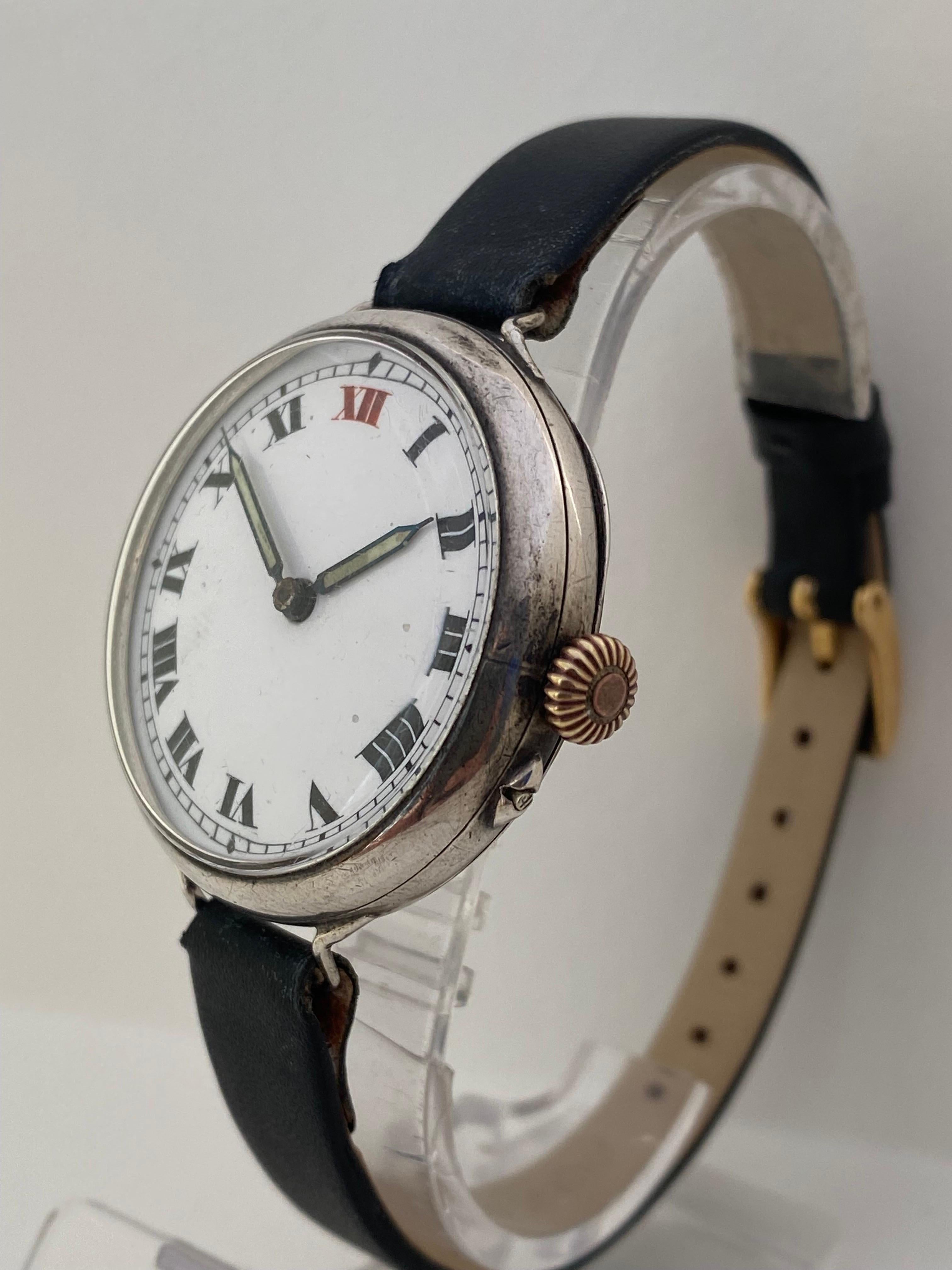This Beautiful 35mm diameter(excluding winder) mechanical silver trench watch is in good working condition and it is running well. Visible signs of ageing and wear with tiny and light marks on the case surface as shown. The black leather strap
