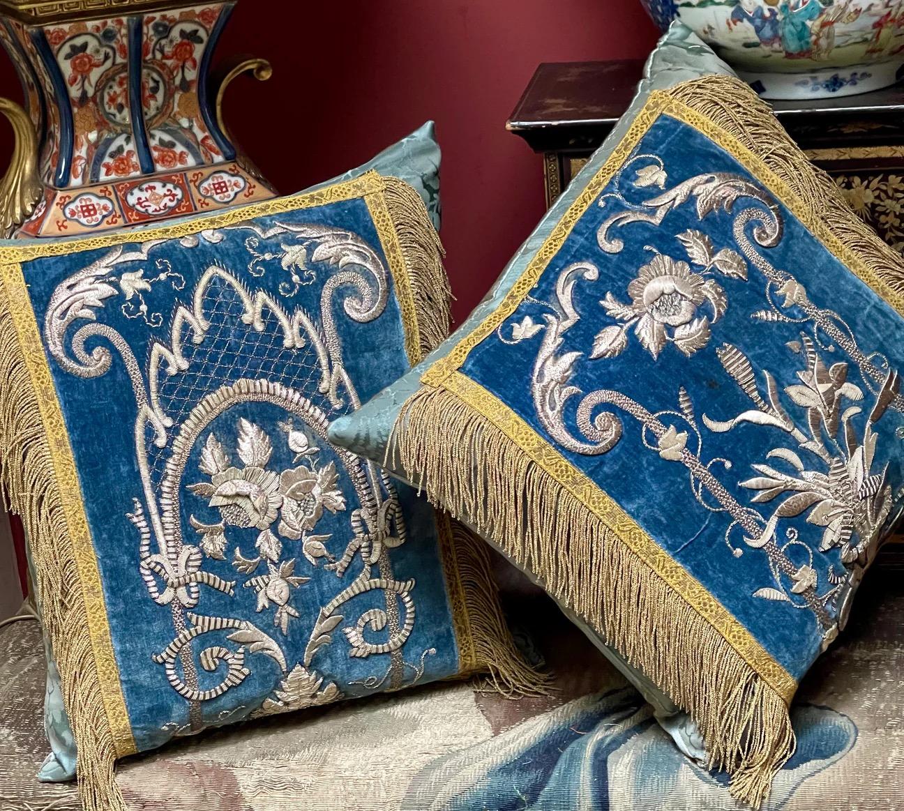 TWO bespoke hand made cushions
Incorporating blue velvet panels embroidered in the most intricate raised and padded Silver metal embroidery of the highest standard

Spanish and dating from mid 19th century

Laid over 18th century Teal blue/green