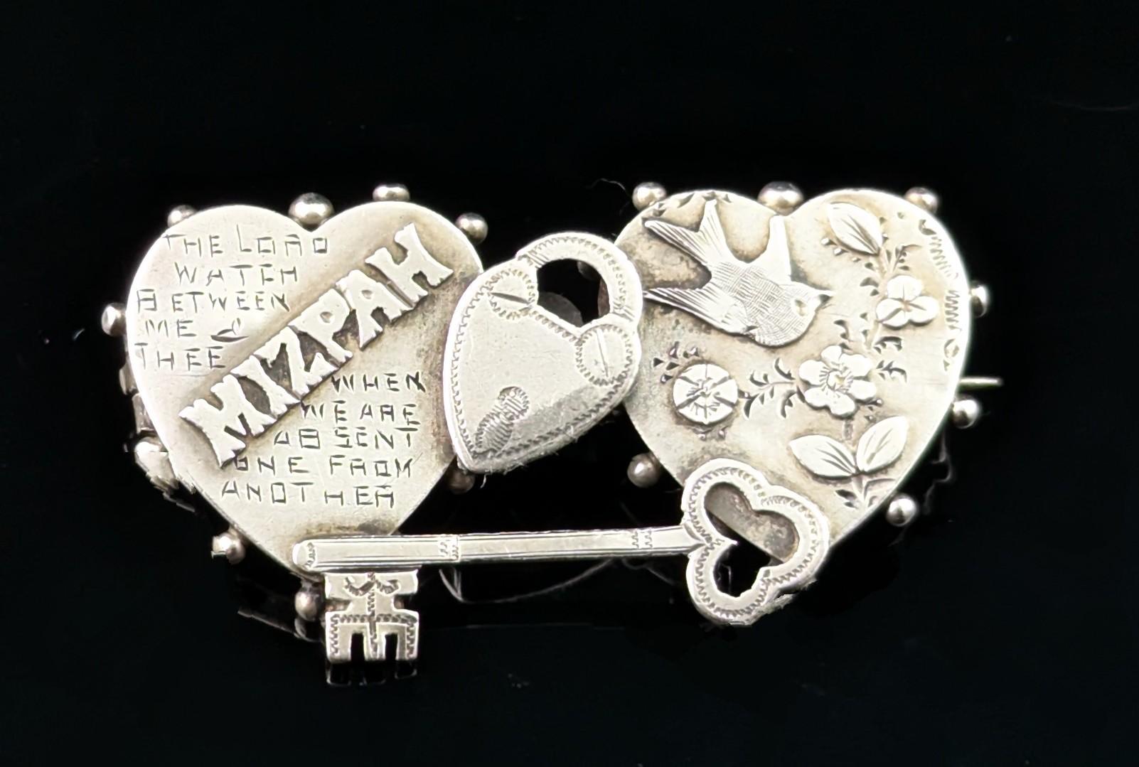 A wonderful antique sterling silver Mizpah Crescent brooch.

Steeped in sentiment this beautiful brooch has stacks of romantic symbolism.

It features a double heart design with the word Mizpah along with a prayer engraved inside one heart and a