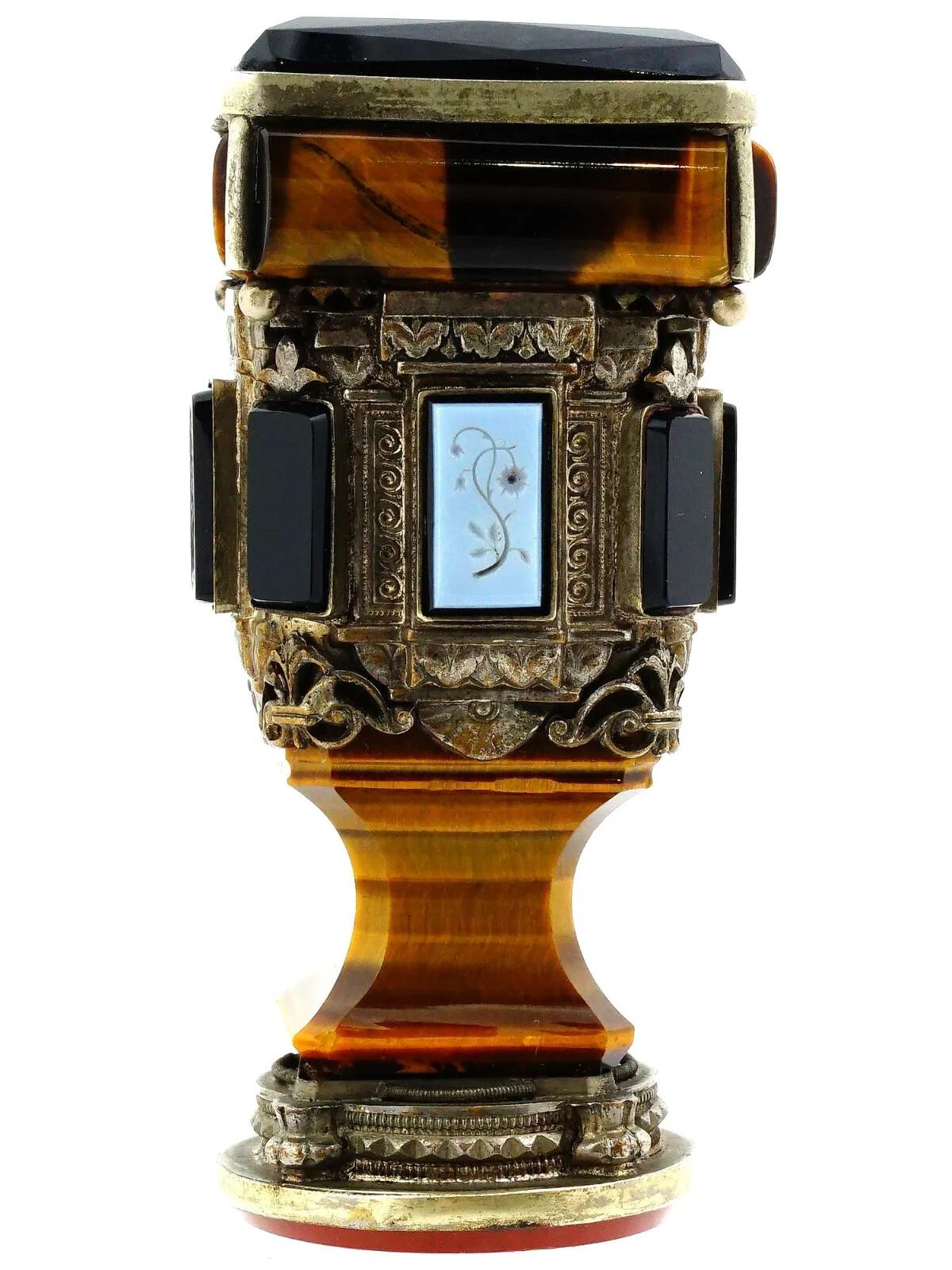 A gilt silver hand seal. Square in cut, richly embossed with ornamental decor and set with tigers eye and onyx stones. The stamp part is set with a carnelian. Unmarked. Collectible Desk Accessories, Writing Instruments, Mineral Stone