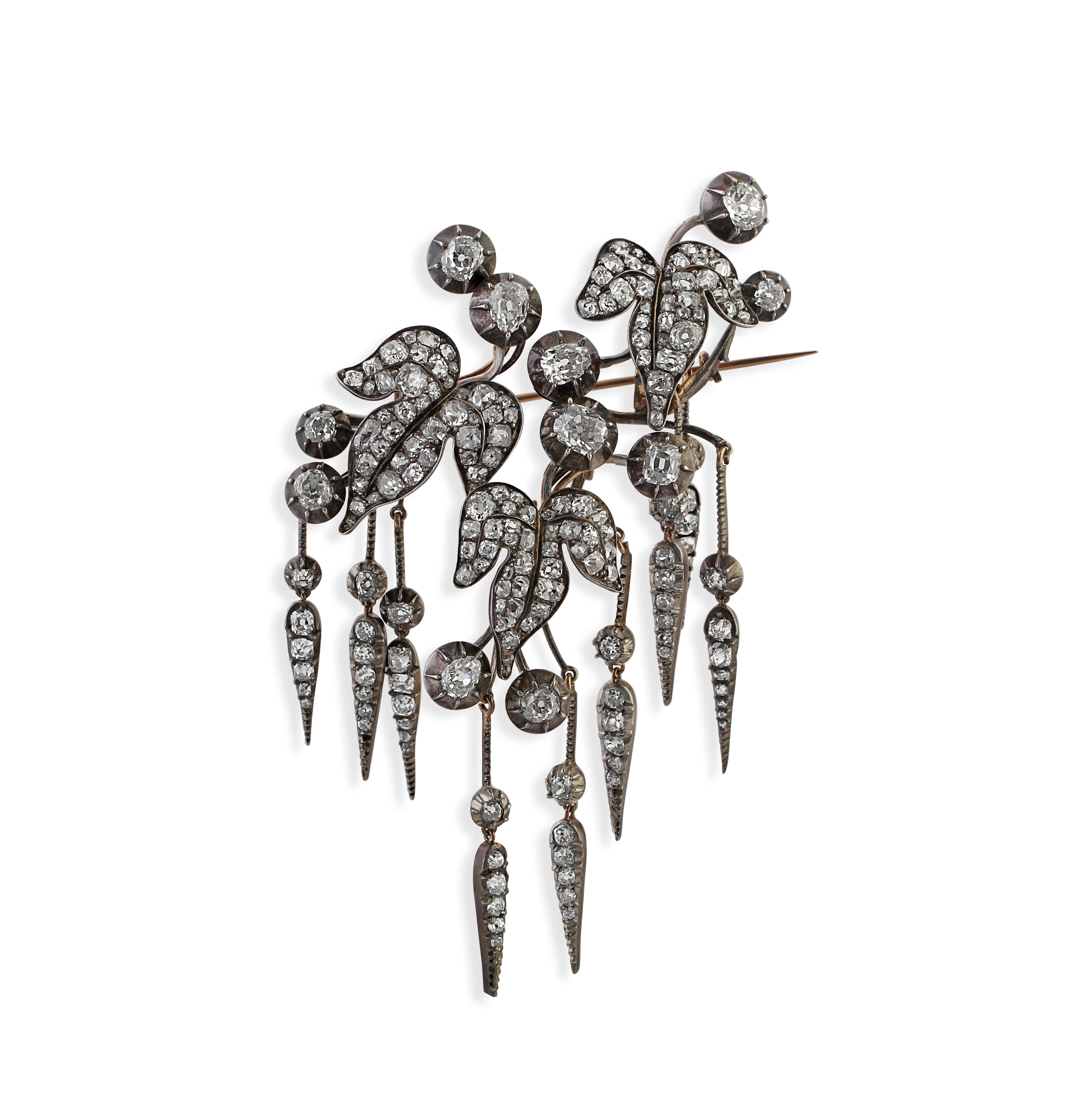 An exceptional antique diamond brooch, stylised as ivy leaves with delicate drops. The piece is set throughout with old and rose cut diamonds. Total diamonds weight = approximately 14-14.50 carats.
