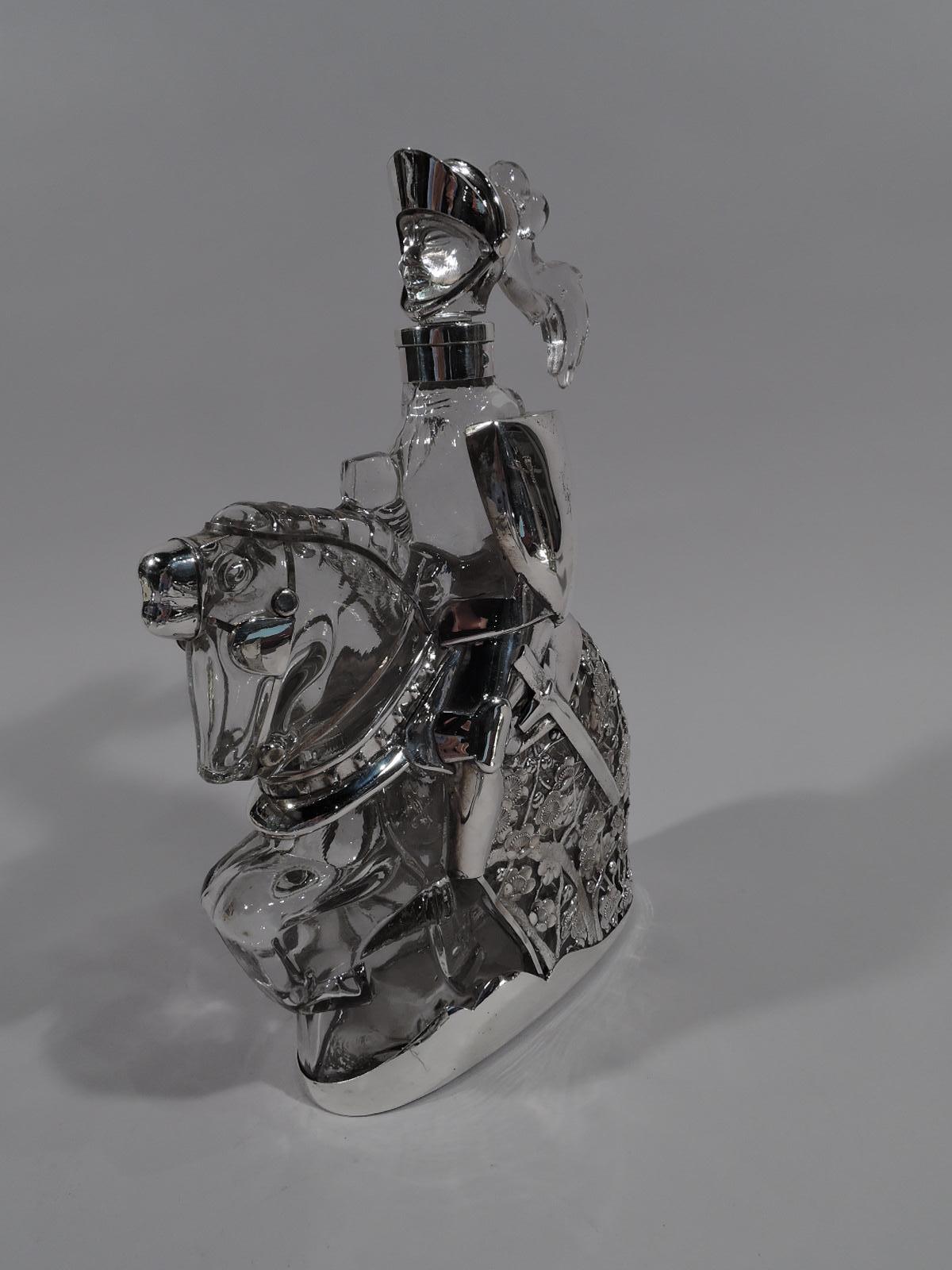Novelty clear glass and silver decanter, circa 1920. A knight errant sits astride a mighty steed, bearing shield and sword. He charges ahead, with helmet plume trailing in wind. Horse covered with dense floral armor to protect your precious tipple