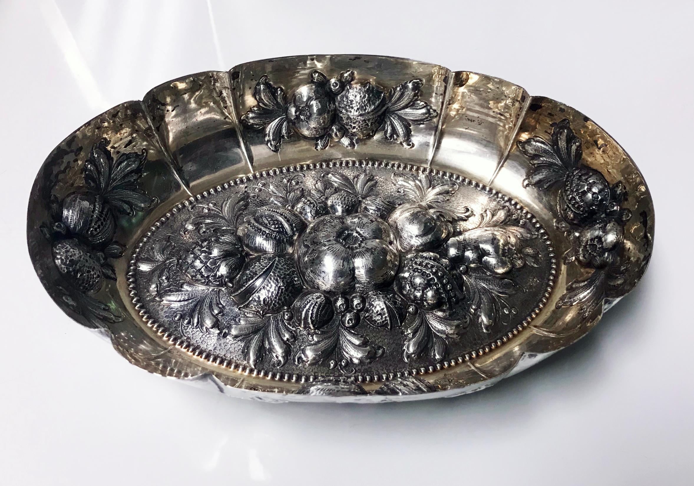 Antique silver parcel gilt fruit dish, Germany, circa 1880. Oval form in the style of the 16th-17th century silver, embossed with scrolling foliage and fruits. The hand embossed decoration is very fine, the dish with 13 Loth mark and L in script,