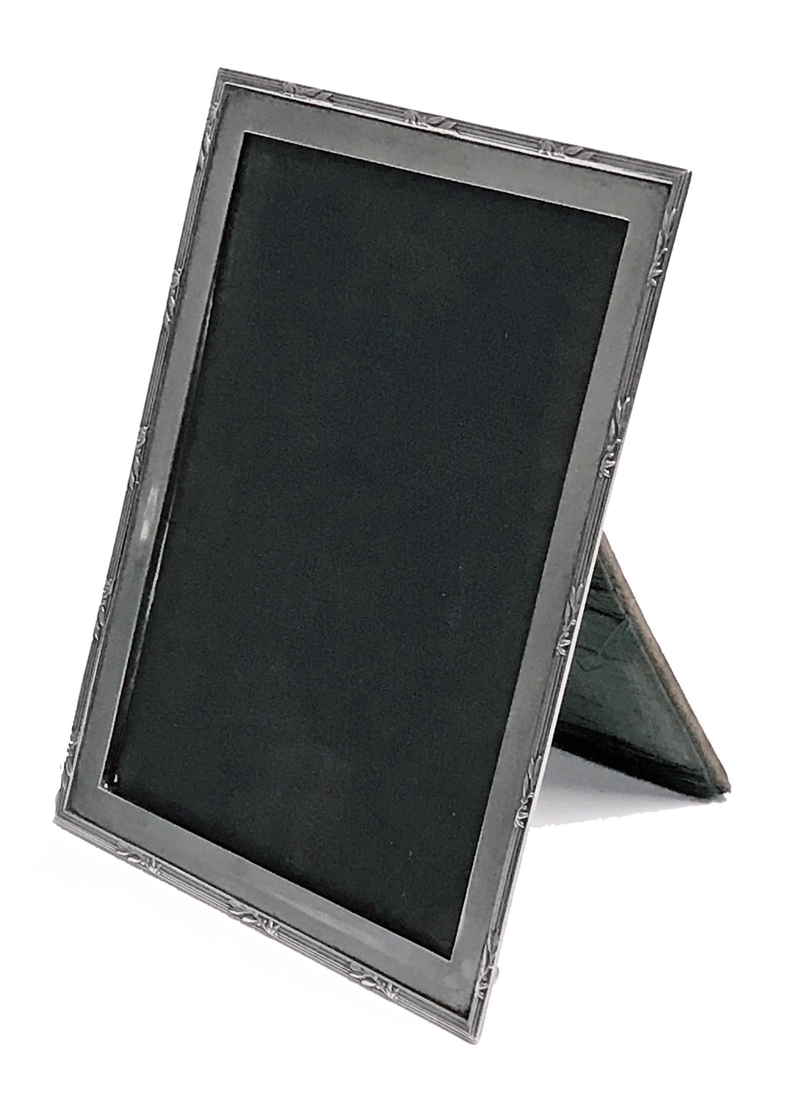 Antique Silver Photograph Frame, Birmingham 1919, E. Mander and Son. Rectangular plain form with ribbon tie border, original velvet back. Minor wear commensurate with age. Measures: 6.00 x 4.50 inches. (image approximately 5.50 x 4.00 inches)