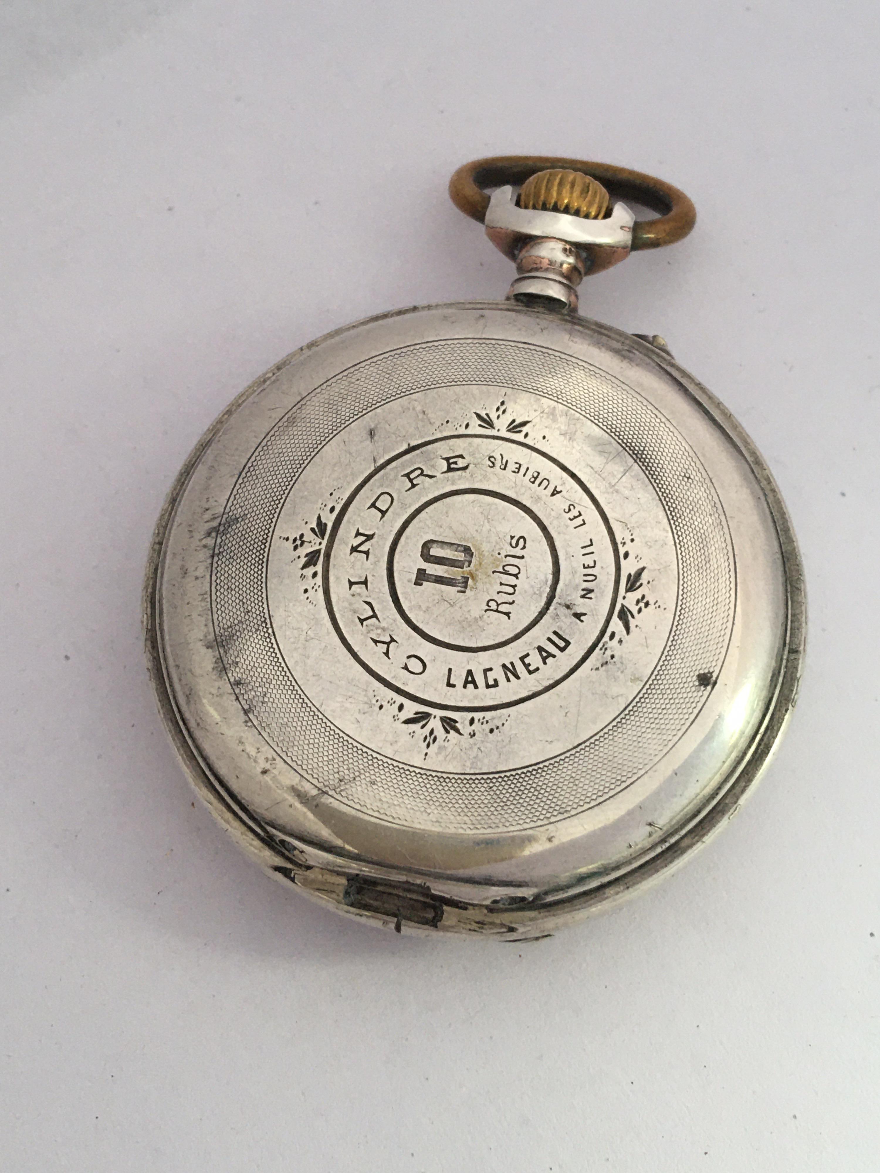 This beautiful antique 48mm diameter hand winding pocket watch is working and  it keeps a good time. Visible signs of ageing and wear with light marks and dents on the watch case as shown. The back cover case is missing as shown.Please study the