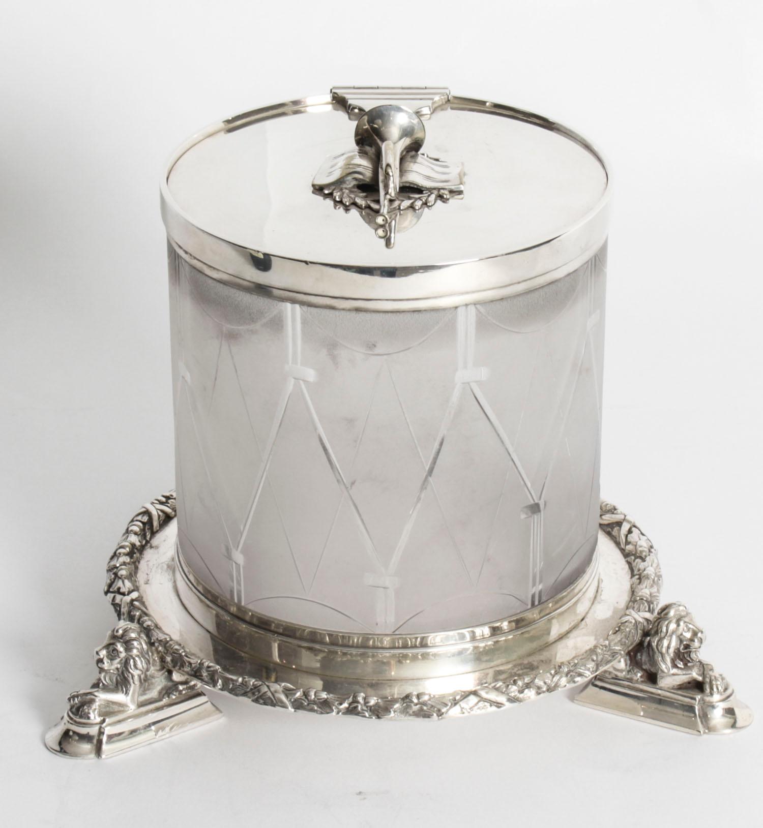 This is an exquisite cut glass and silver plate biscuit box bearing the makers mark TH & S the inventory number 7099, and dating from the late 19th century.

The glass is engraved to look like a drim and it stands on a silver plated circular base