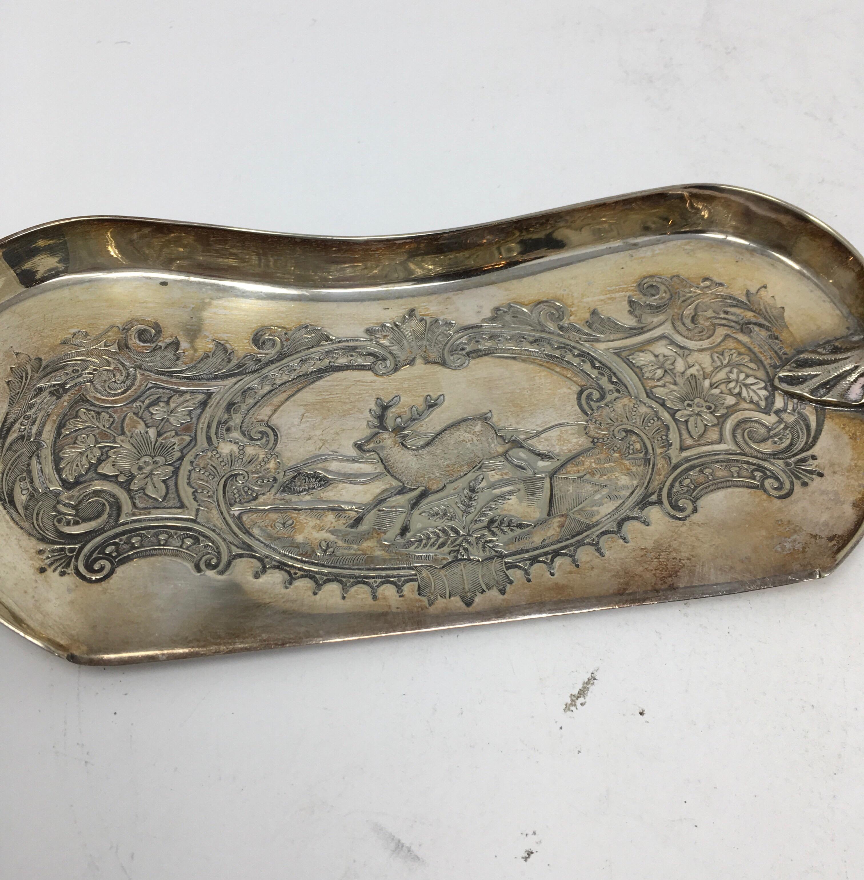 This is an antique silver plate crumber with hallmarks featuring a stags horn handle from England. The silver plate blade is very decorative, beautifully engraved with a pictorial of a stag running in a field with a border of flowers and leaves.