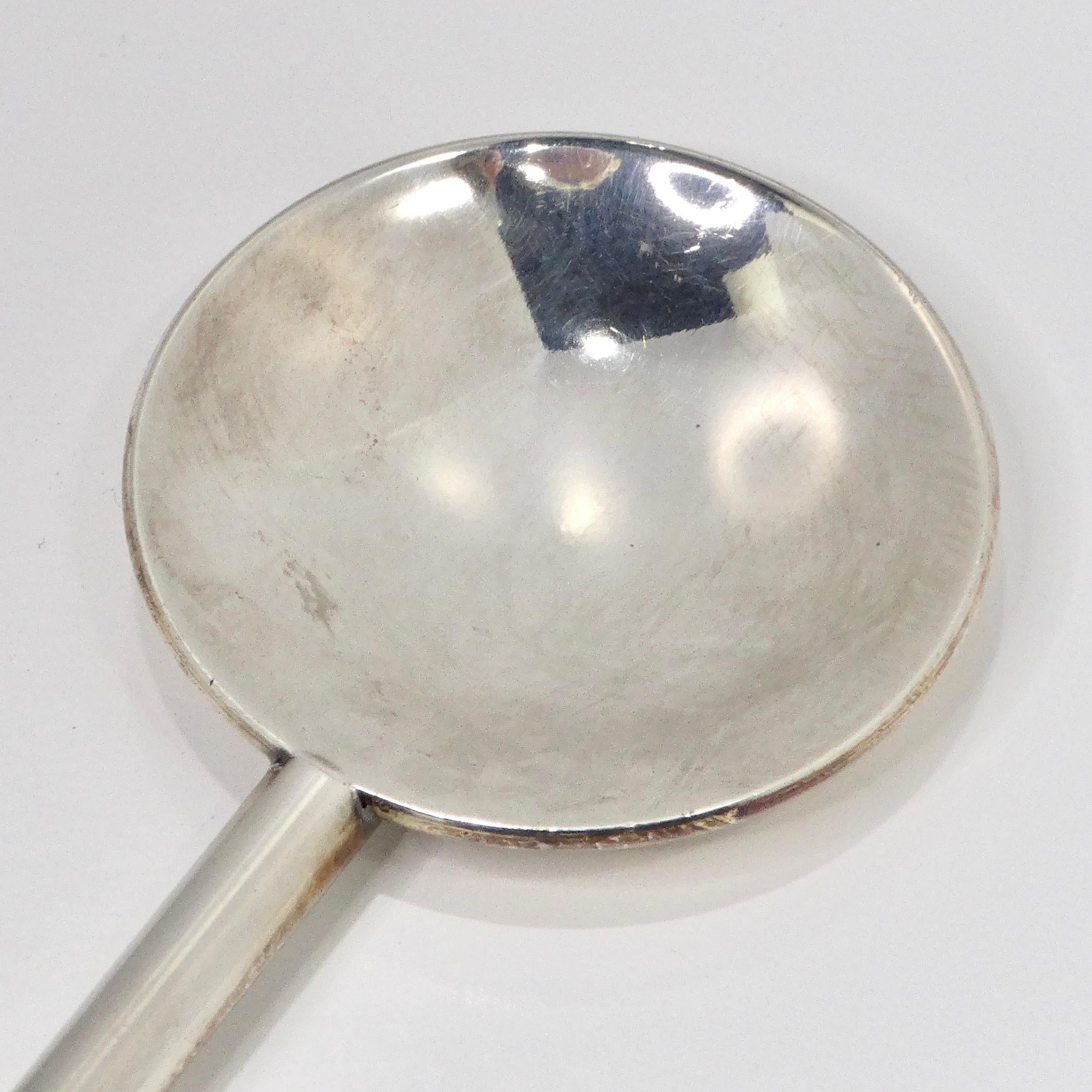 Introducing the Antique Silver Plate Cocktail Spoon, a distinguished piece from the early 1900s that exudes timeless elegance and sophistication.

Crafted with exquisite attention to detail, this silver-plated cocktail spoon is a luxurious addition