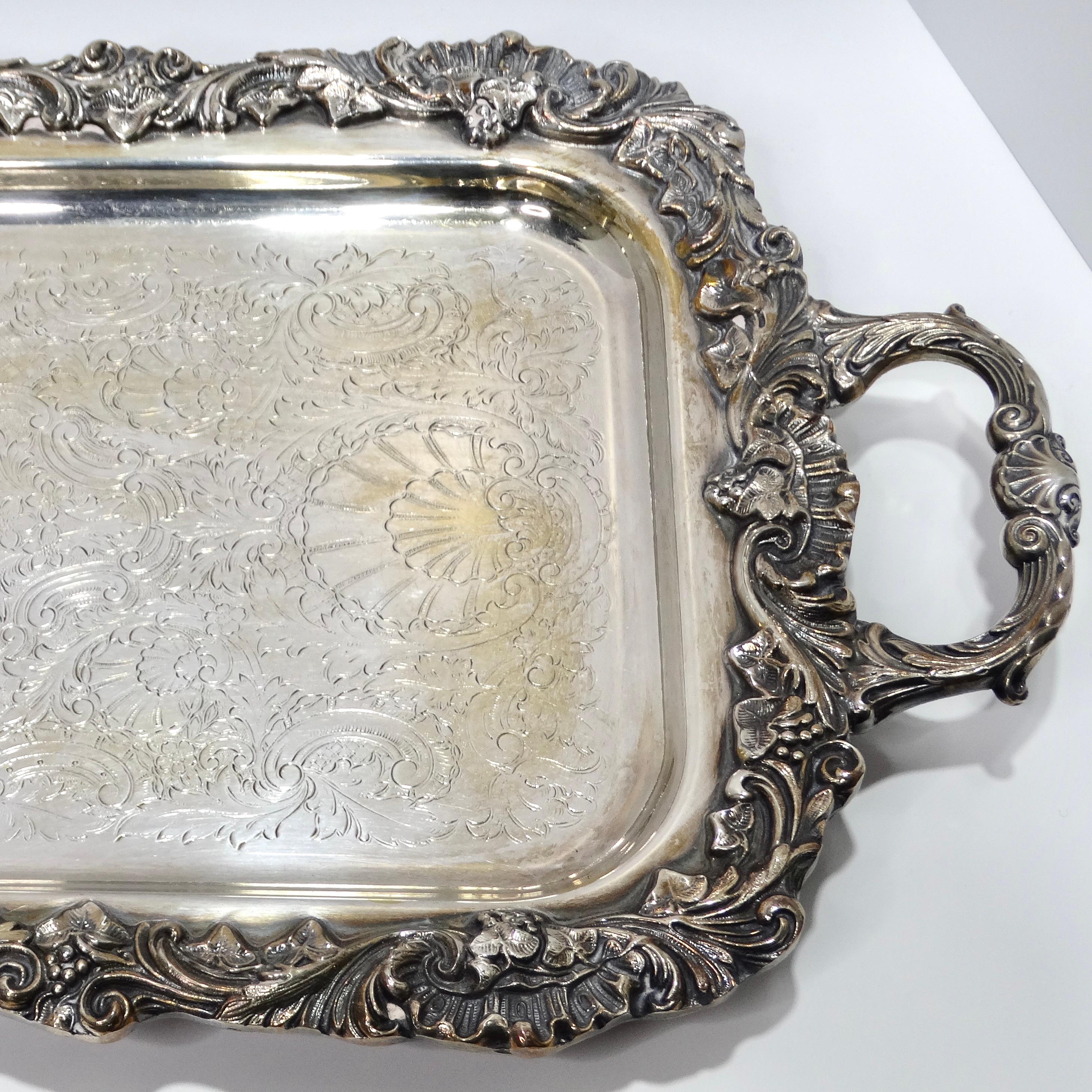 Introducing the Antique Silver Plate Cocktail Tray, a magnificent piece that adds a touch of sophistication to your entertaining endeavors.

Crafted with intricate detail, this large silver-plated cocktail serving tray, also known as a butler tray,